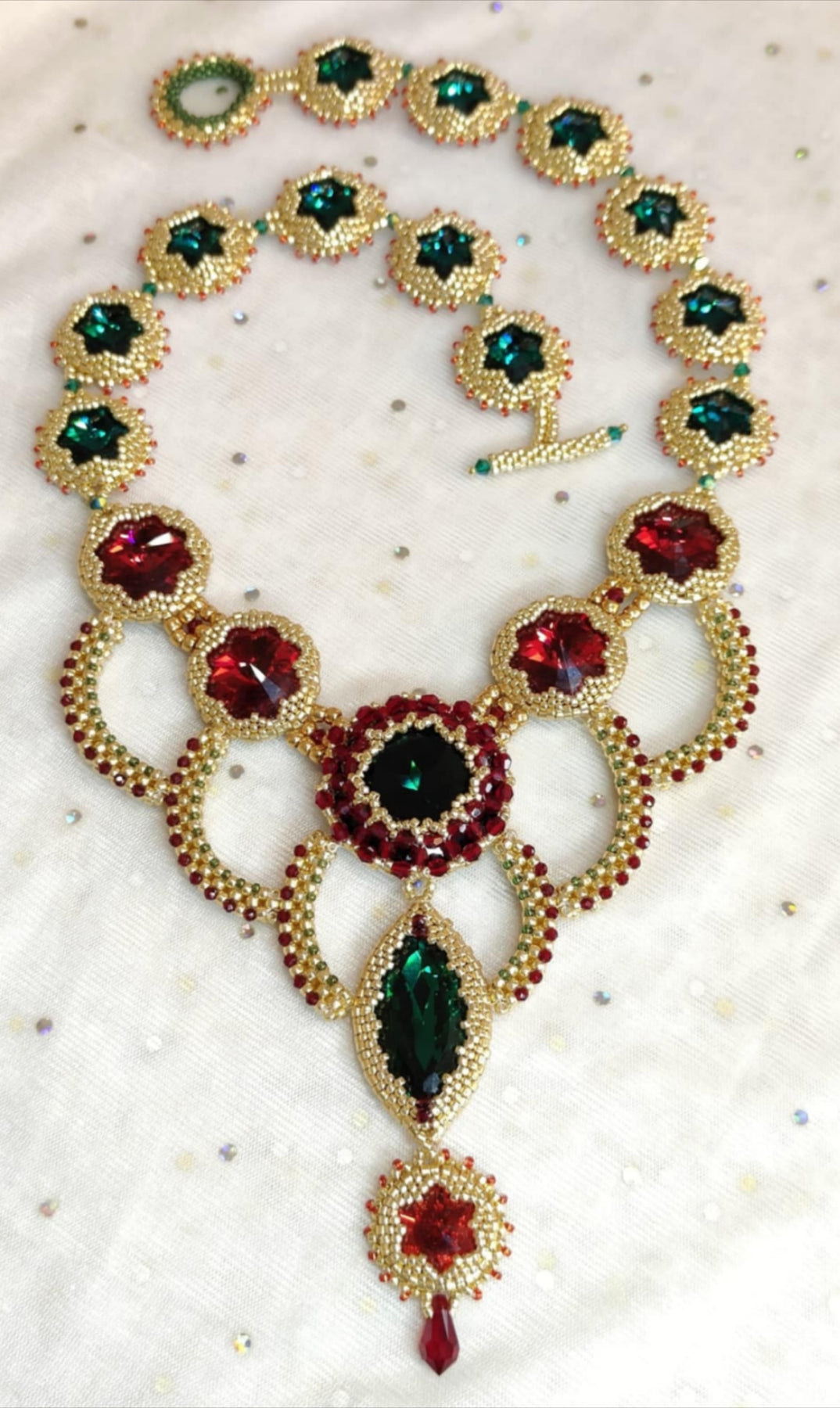 Bead-woven statement necklace with red/green crystal accents