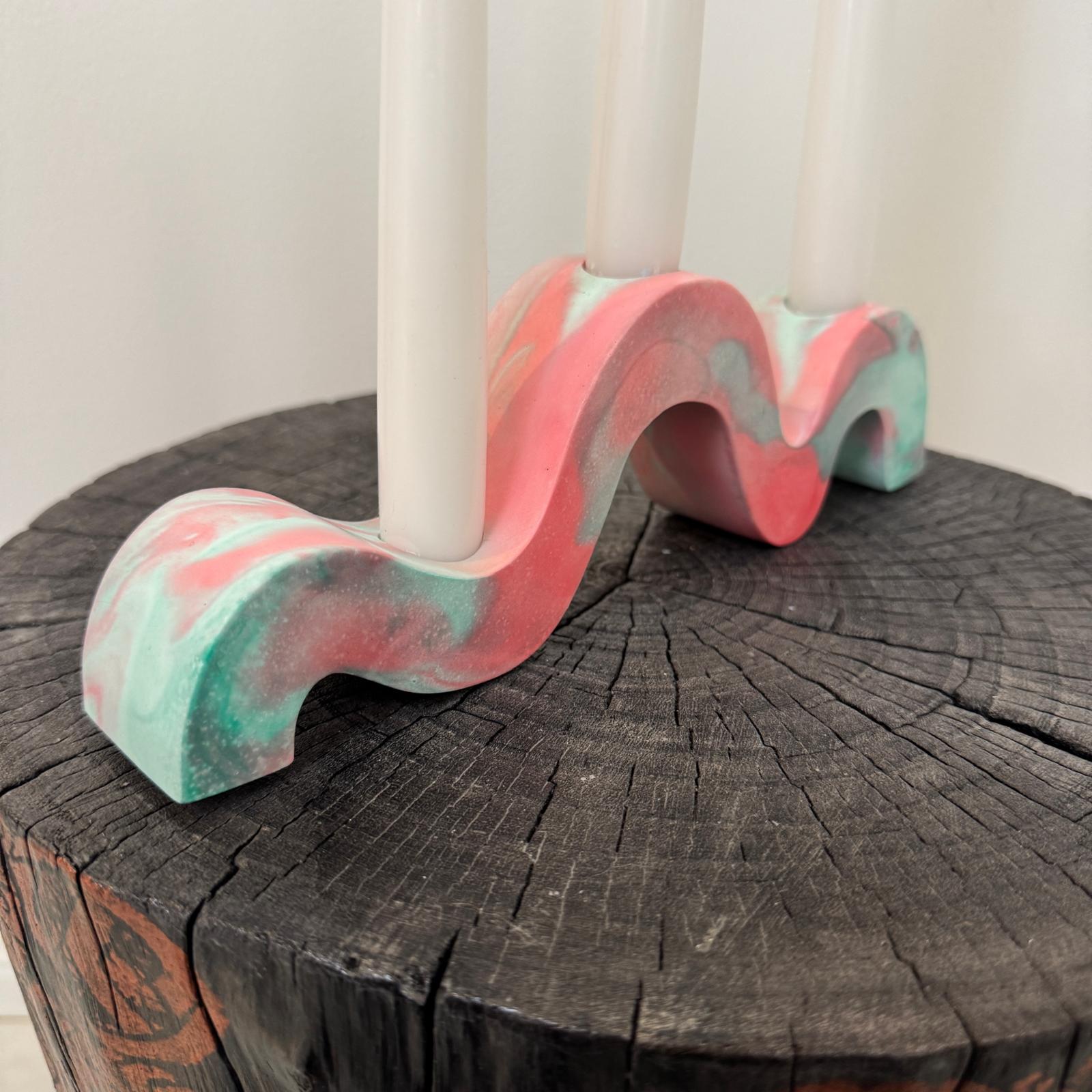 Red and green and gold wavy concrete holder for taper candles