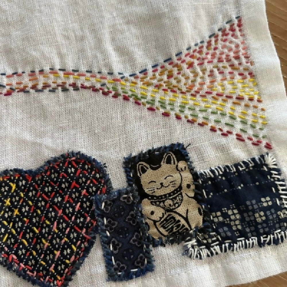 Detail from Lucky Cat handstitched linen teatowel by Leumesin Handmade