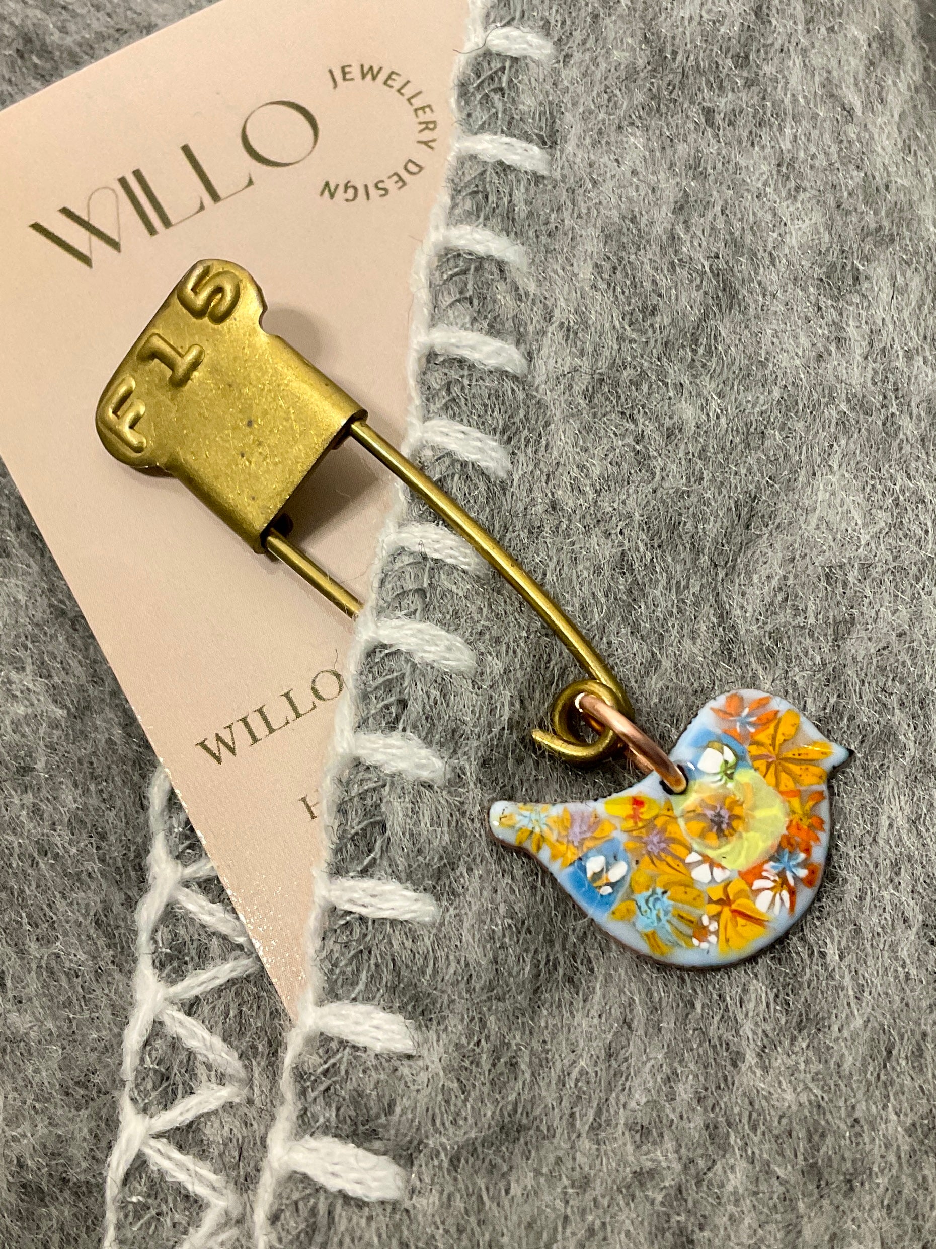 Bird scarf pin.
