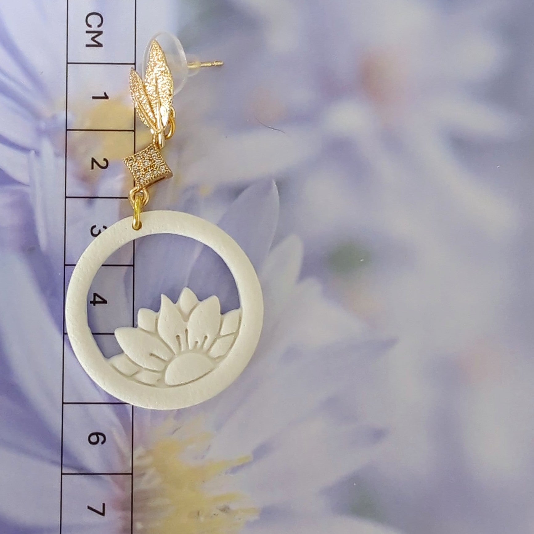 White Earrings With Gold Findings in Different Designs.