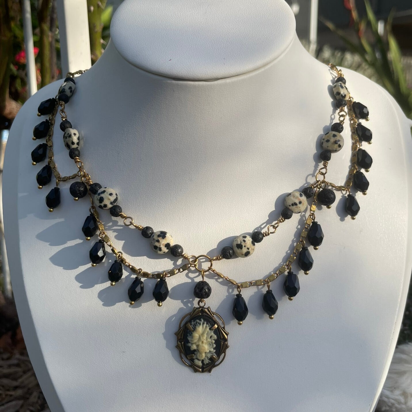 Black and brass beaded statement necklace with cameo charm