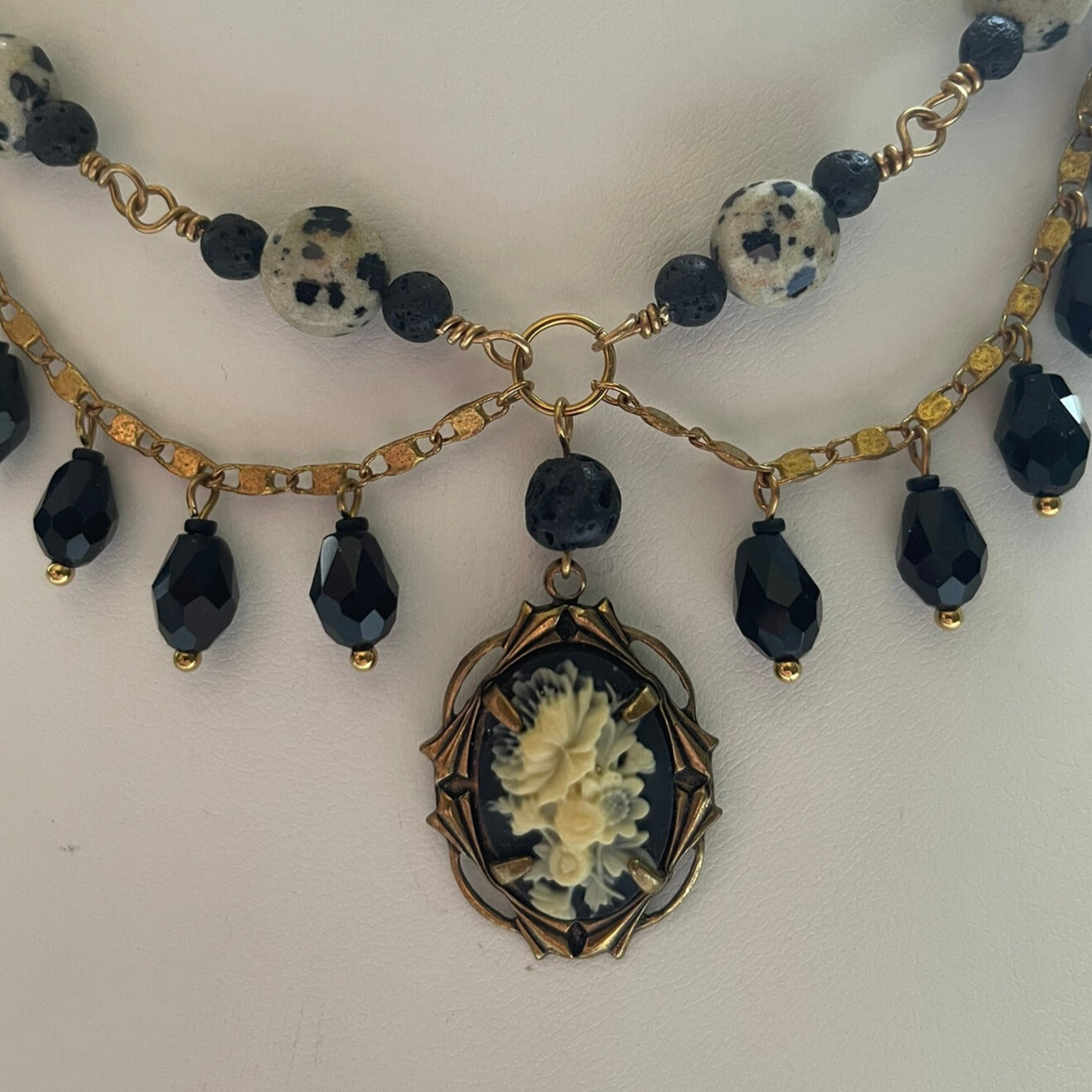 Black and brass beaded statement necklace with cameo charm