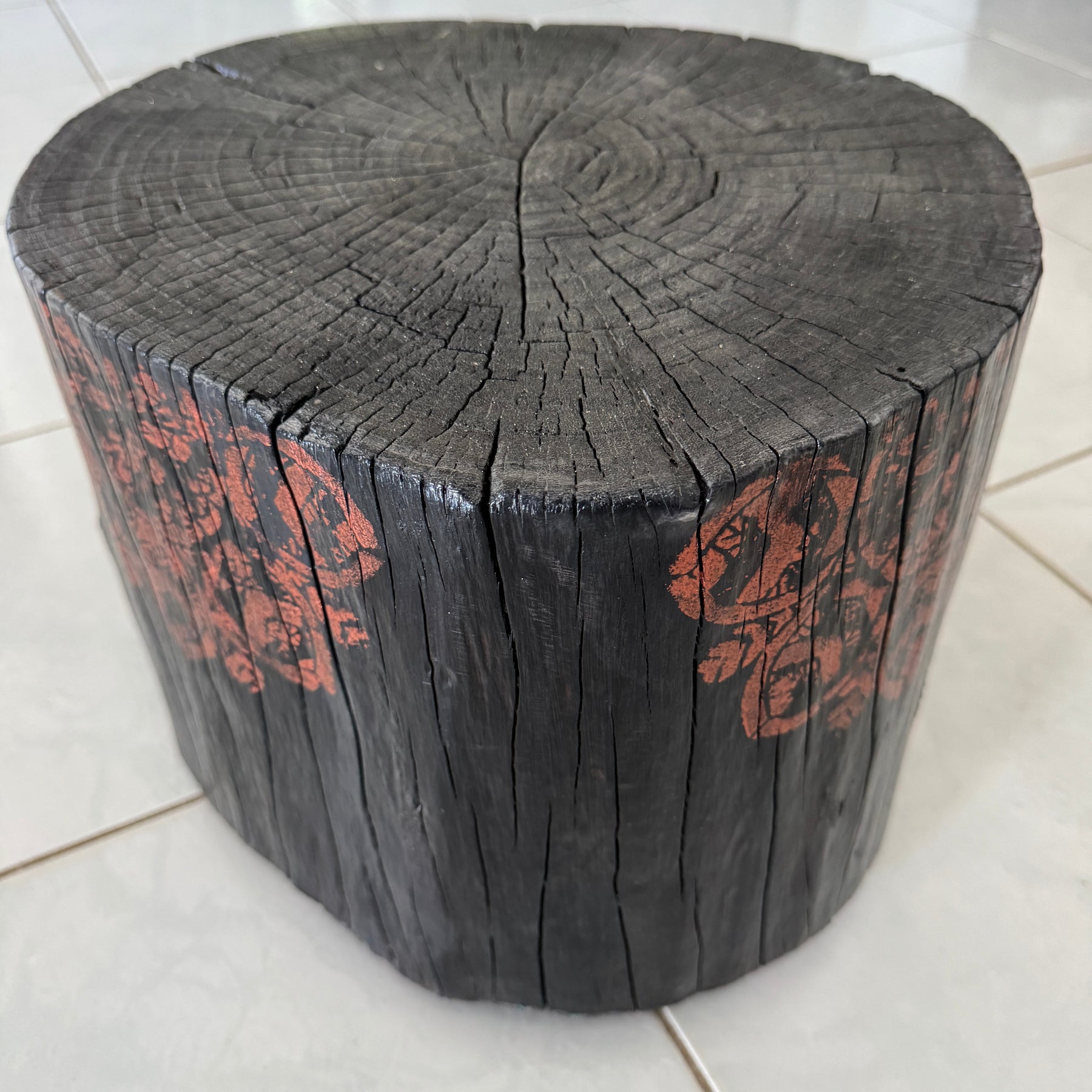 Burnt timber stump table featuring copper mandala artwork