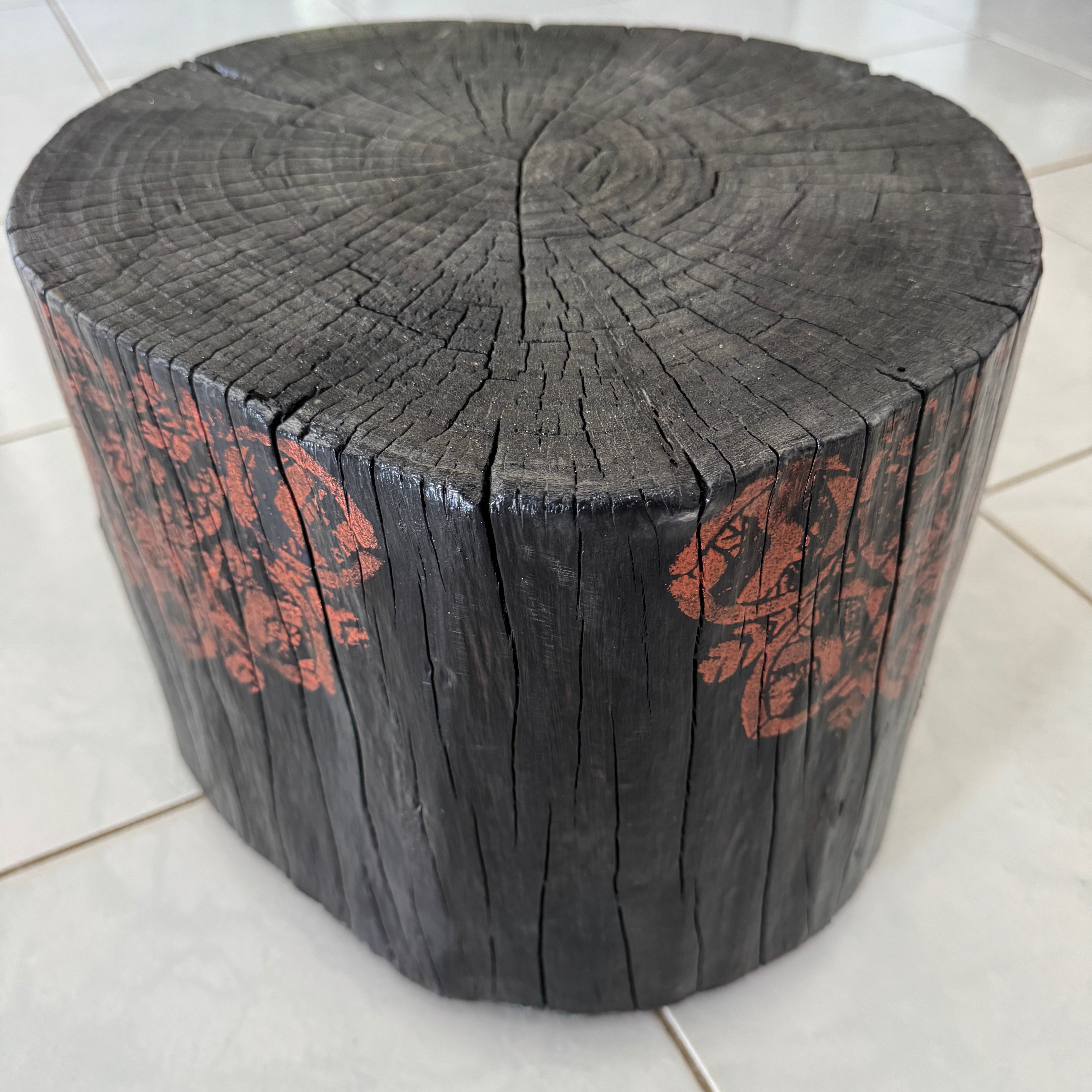 Burnt timber stump table featuring copper mandala artwork