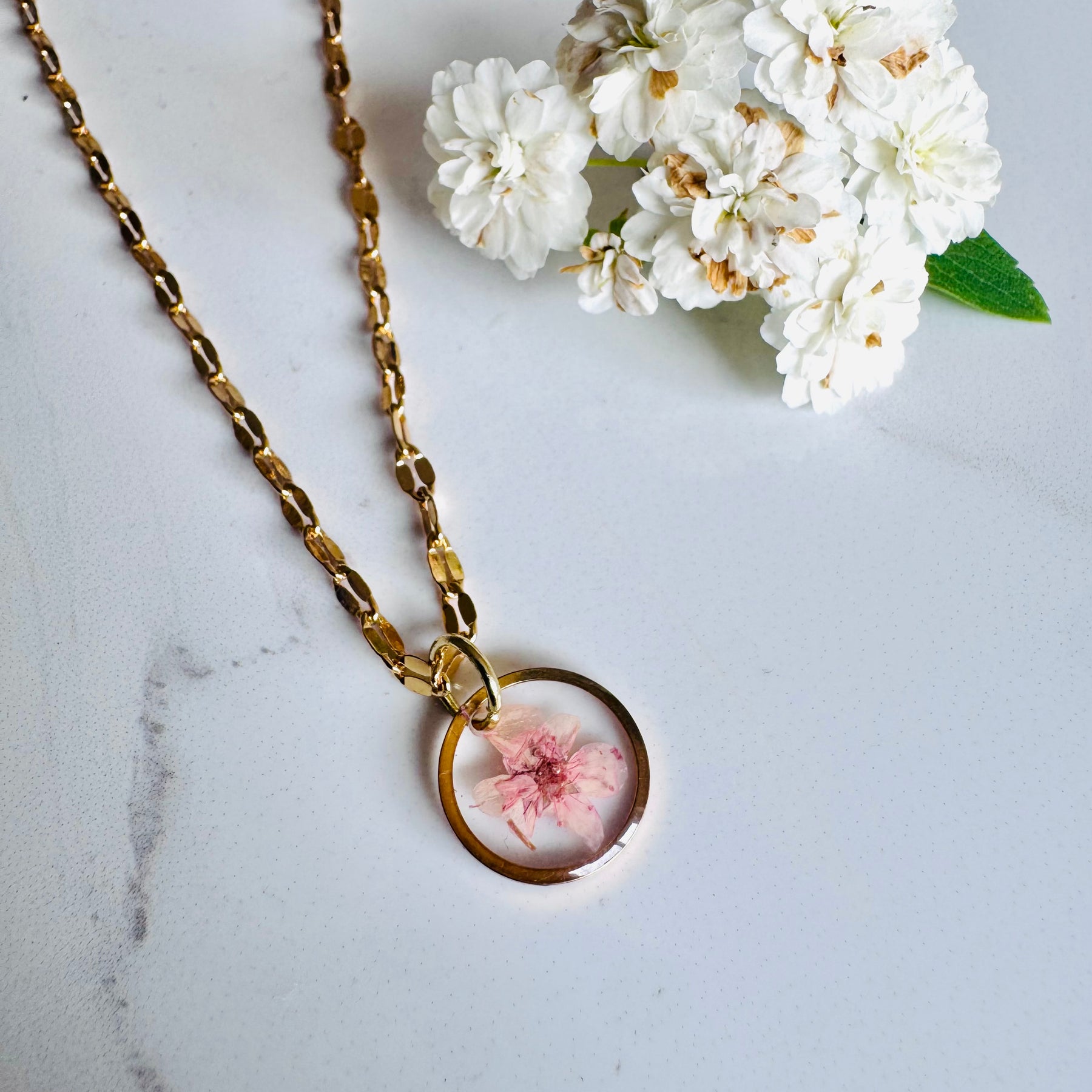 Gold plated resin necklace with pink wildflower