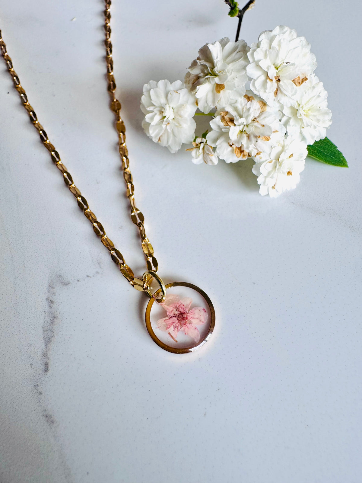 Gold plated resin necklace with pink wildflower