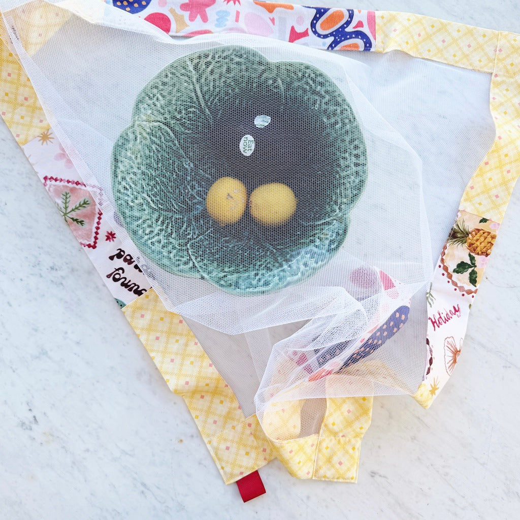 Yellow weighted mesh food cover.