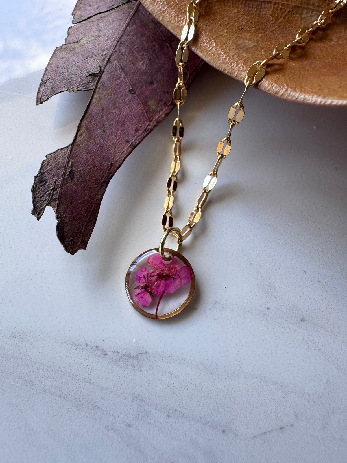Gold plated resin necklace with fuchsia pink wildflower