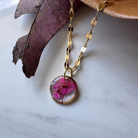Gold plated resin necklace with fuchsia pink wildflower