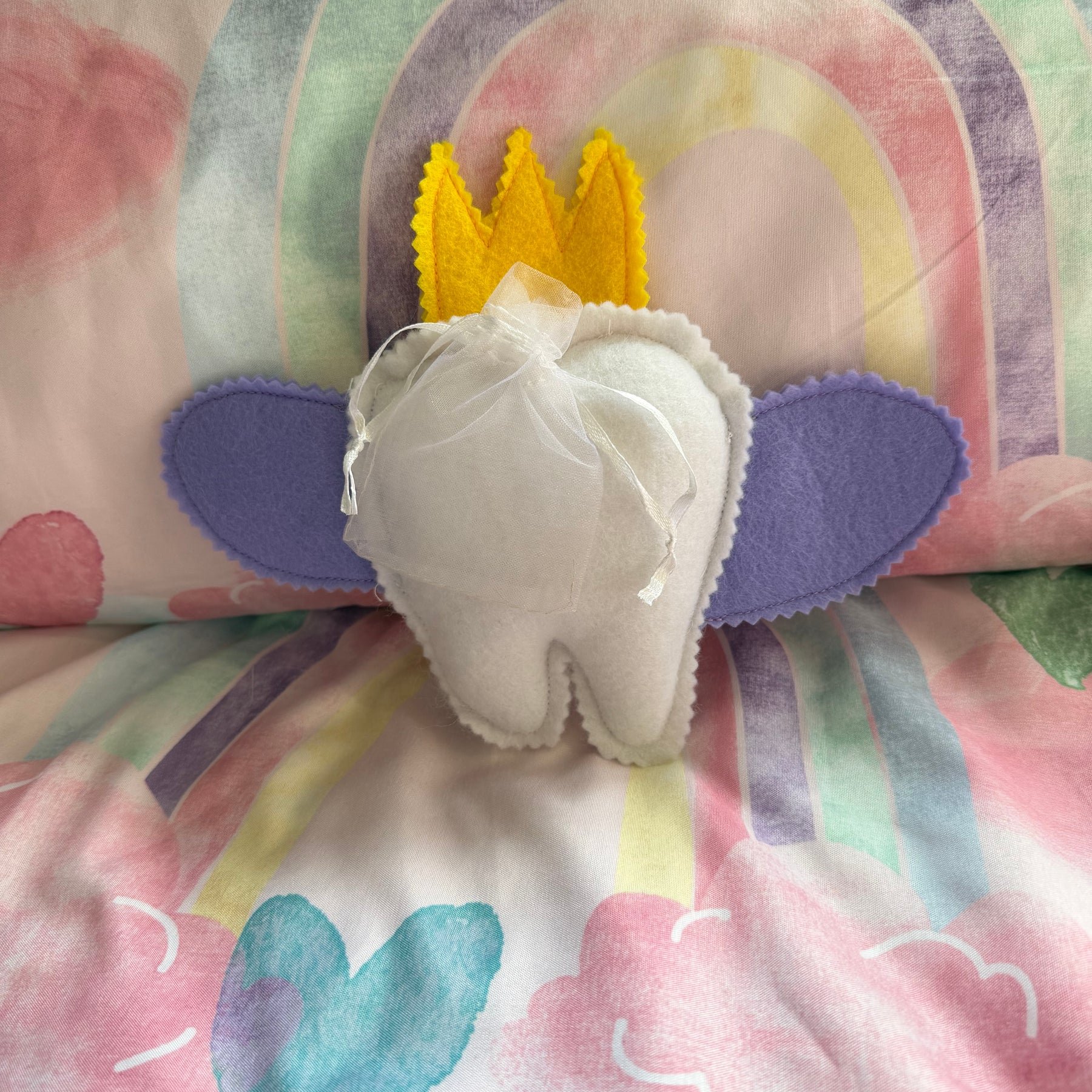 Tooth fairy snuggle toy with tooth pouch