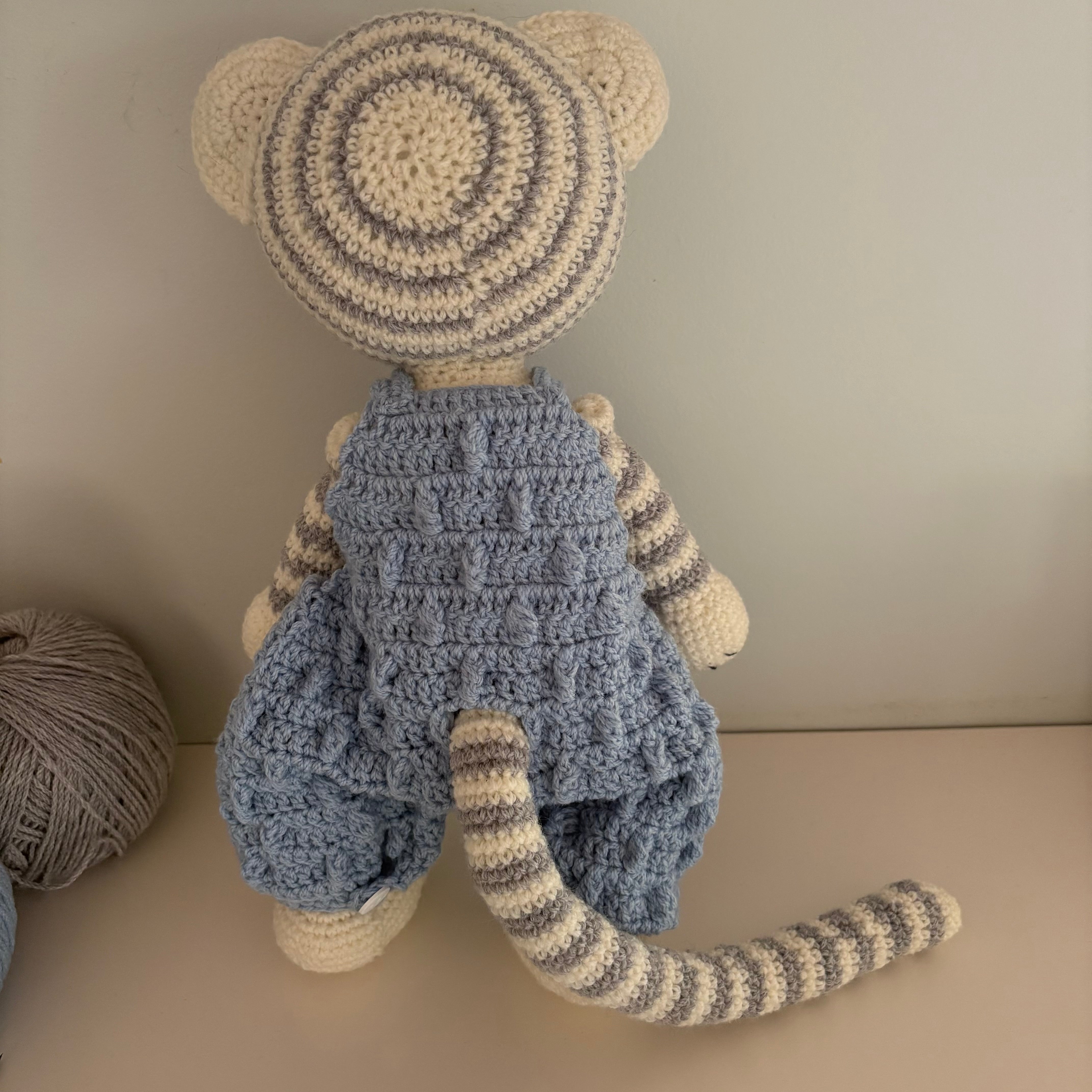 Crochet tiger in blue overalls
