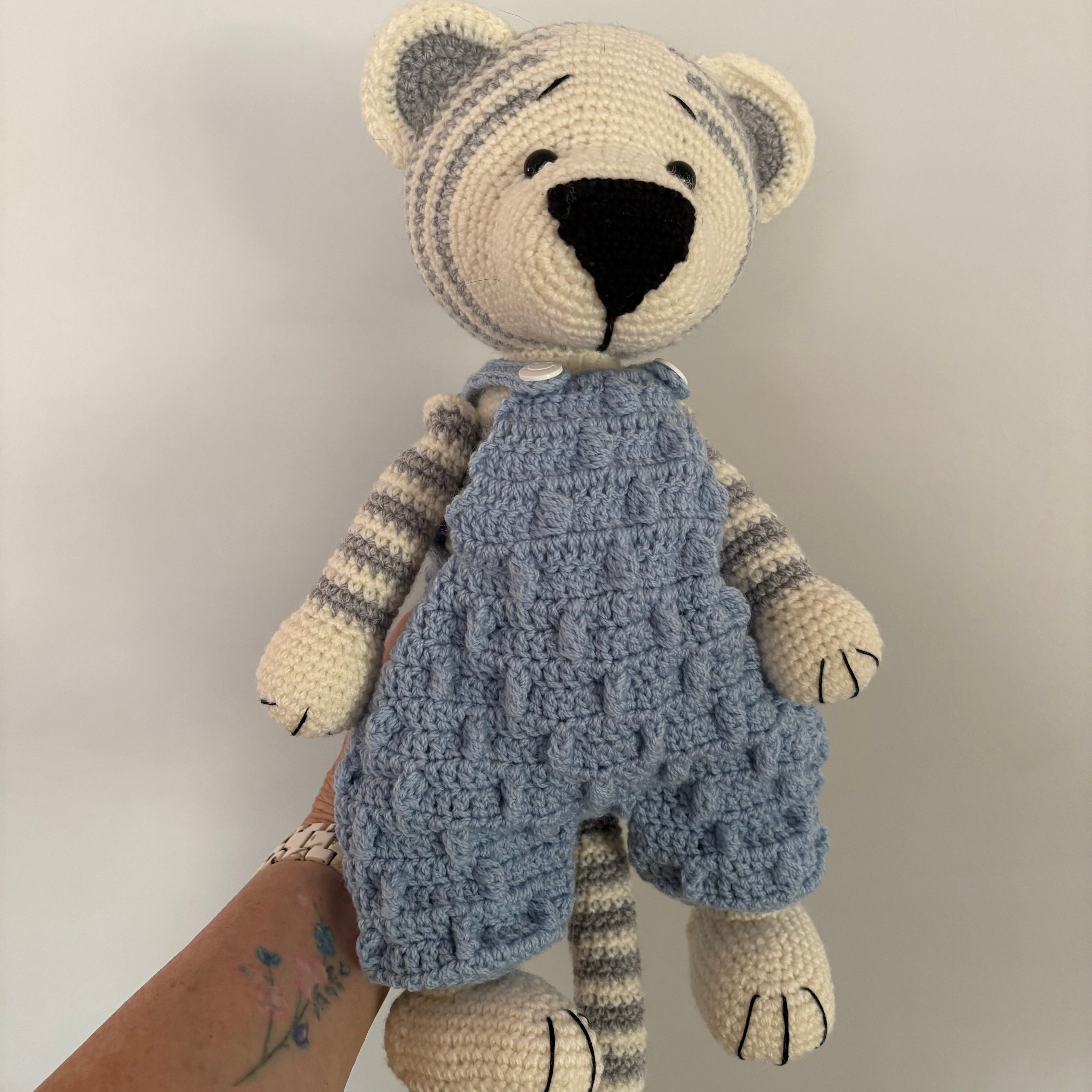 Crochet tiger in blue overalls