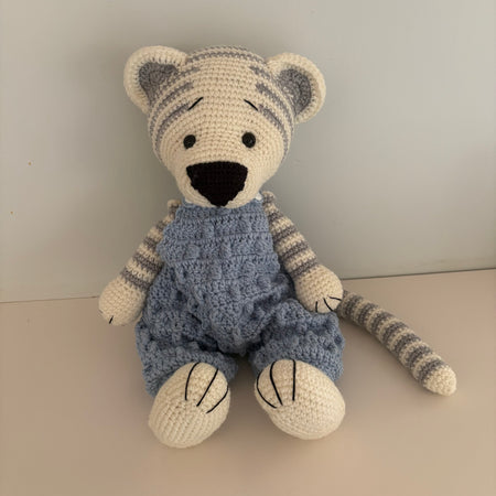 Crochet tiger in blue overalls