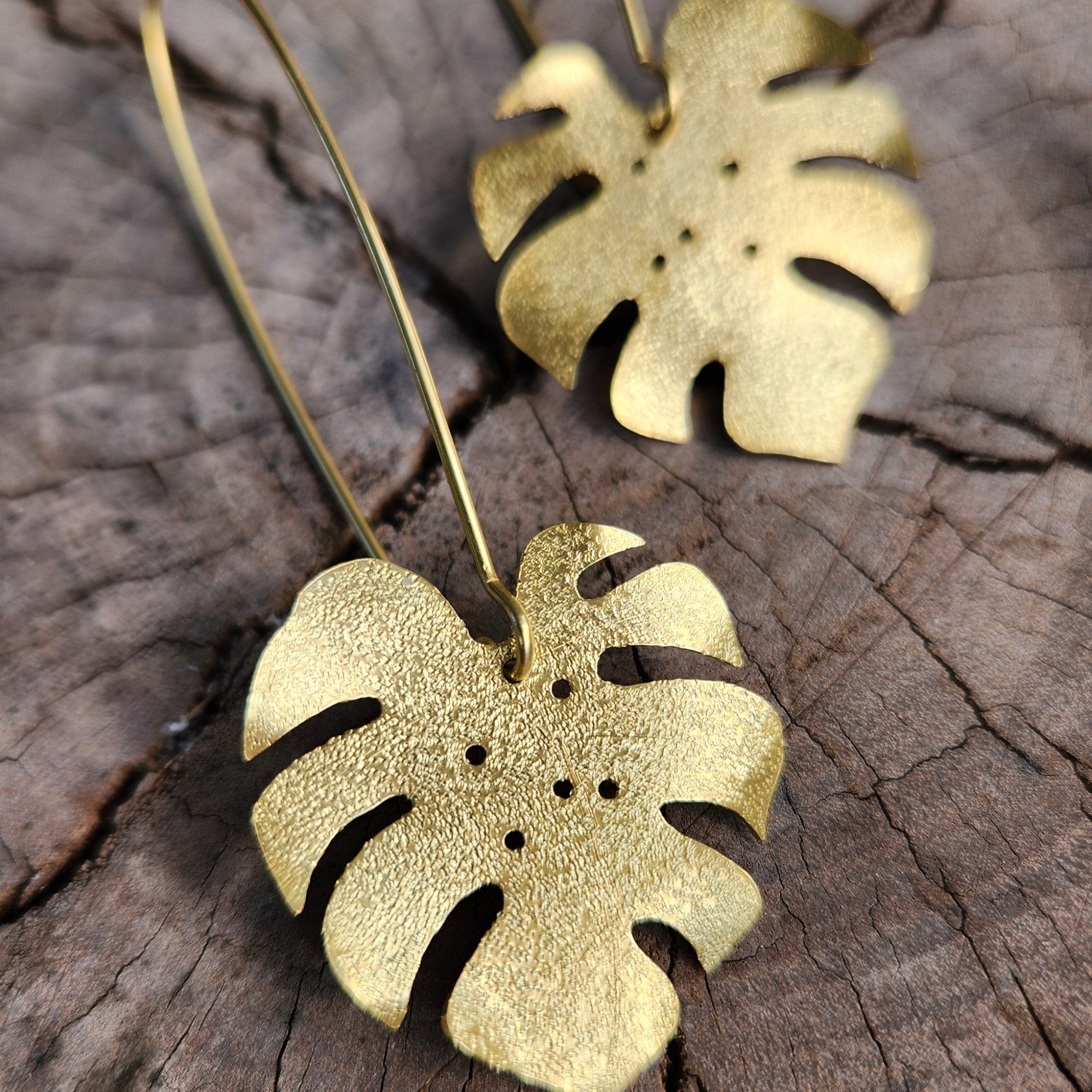 Golden tone monstera earrings