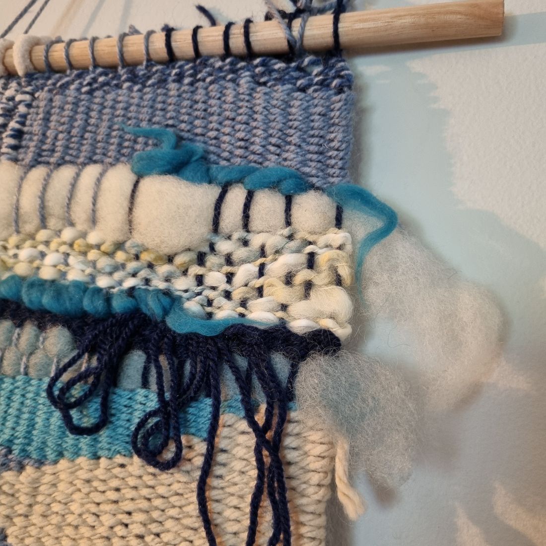 Handwoven wall hanging in blue and cream