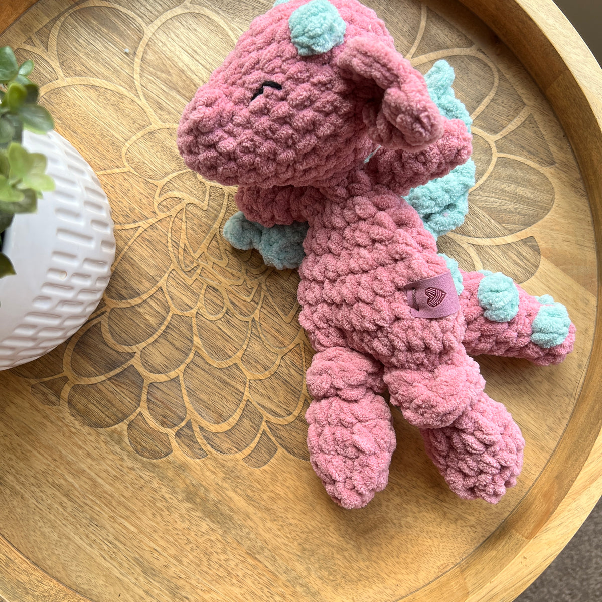 Handmade crochet Mini Dragon modern lovey with knotted legs and rainbow spikes.