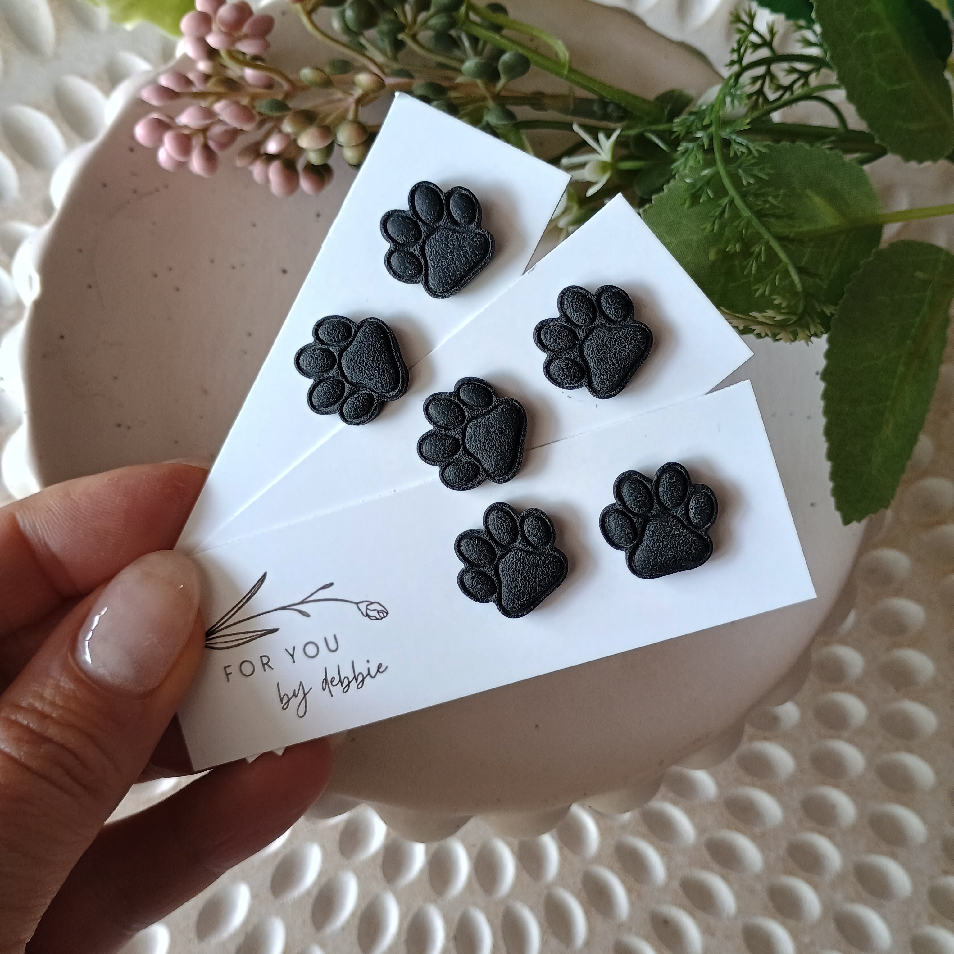 Black paw print stud earrings