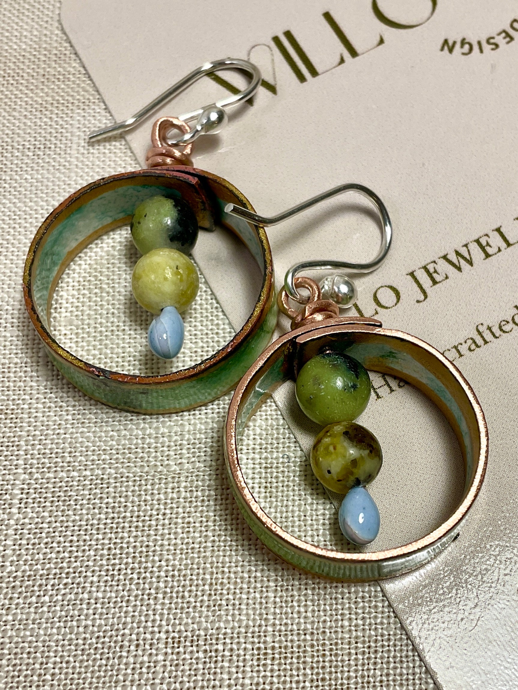 Teal gold and white enamel earrings with gemstone beads.