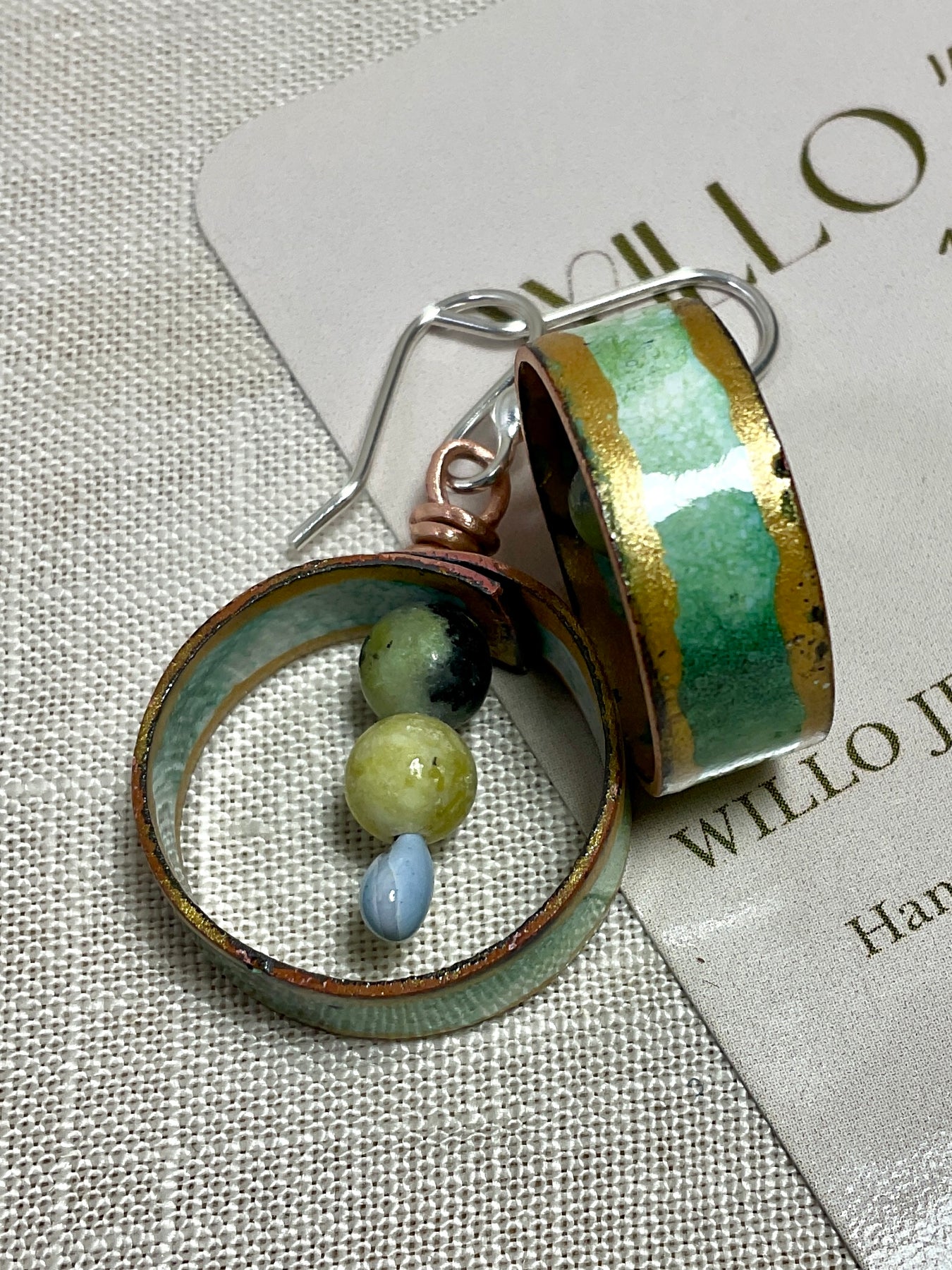 Teal gold and white enamel earrings with gemstone beads.
