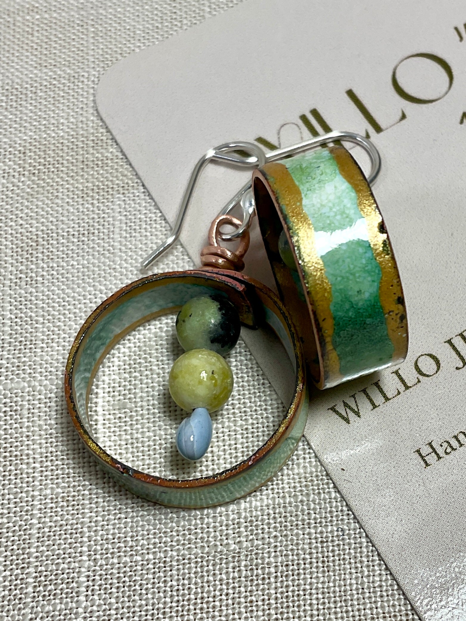 Teal gold and white enamel earrings with gemstone beads.