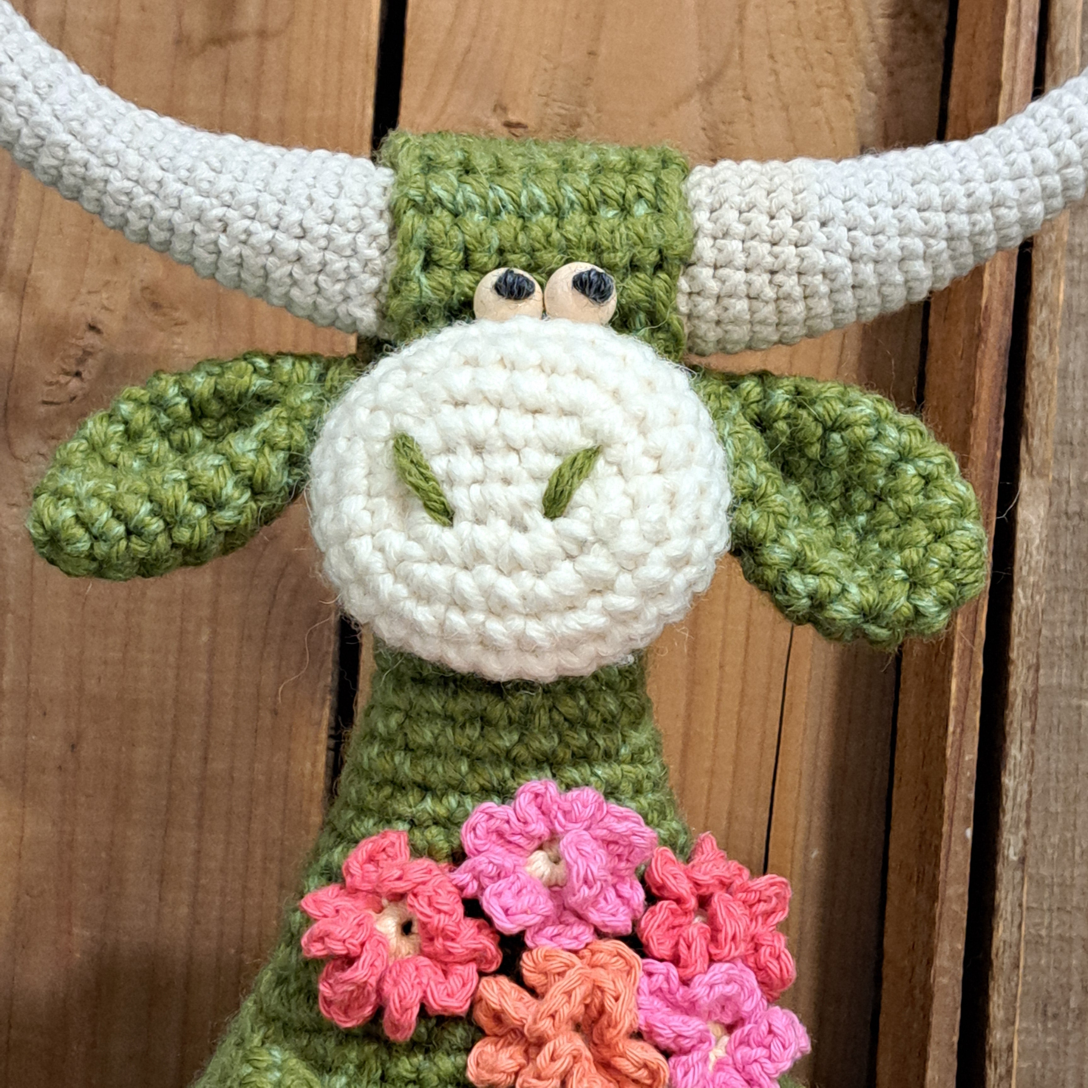 Handmade Highland cow crochet character doorstop in green