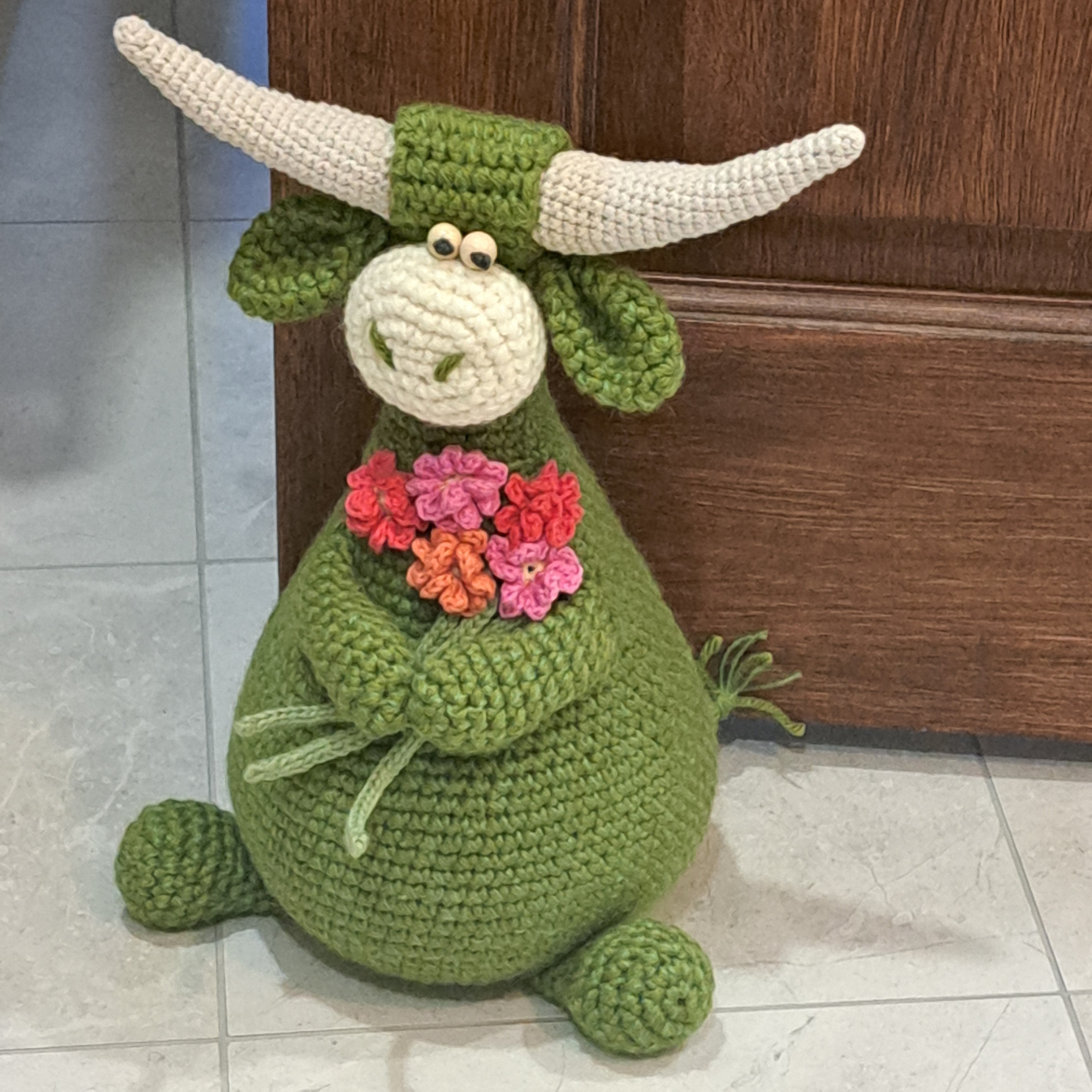 Handmade Highland cow crochet character doorstop in green
