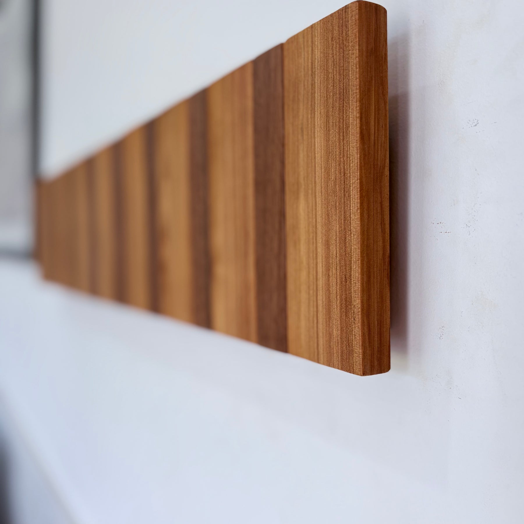 Two tone spotted gum and cypress horizon line piano style coatrack