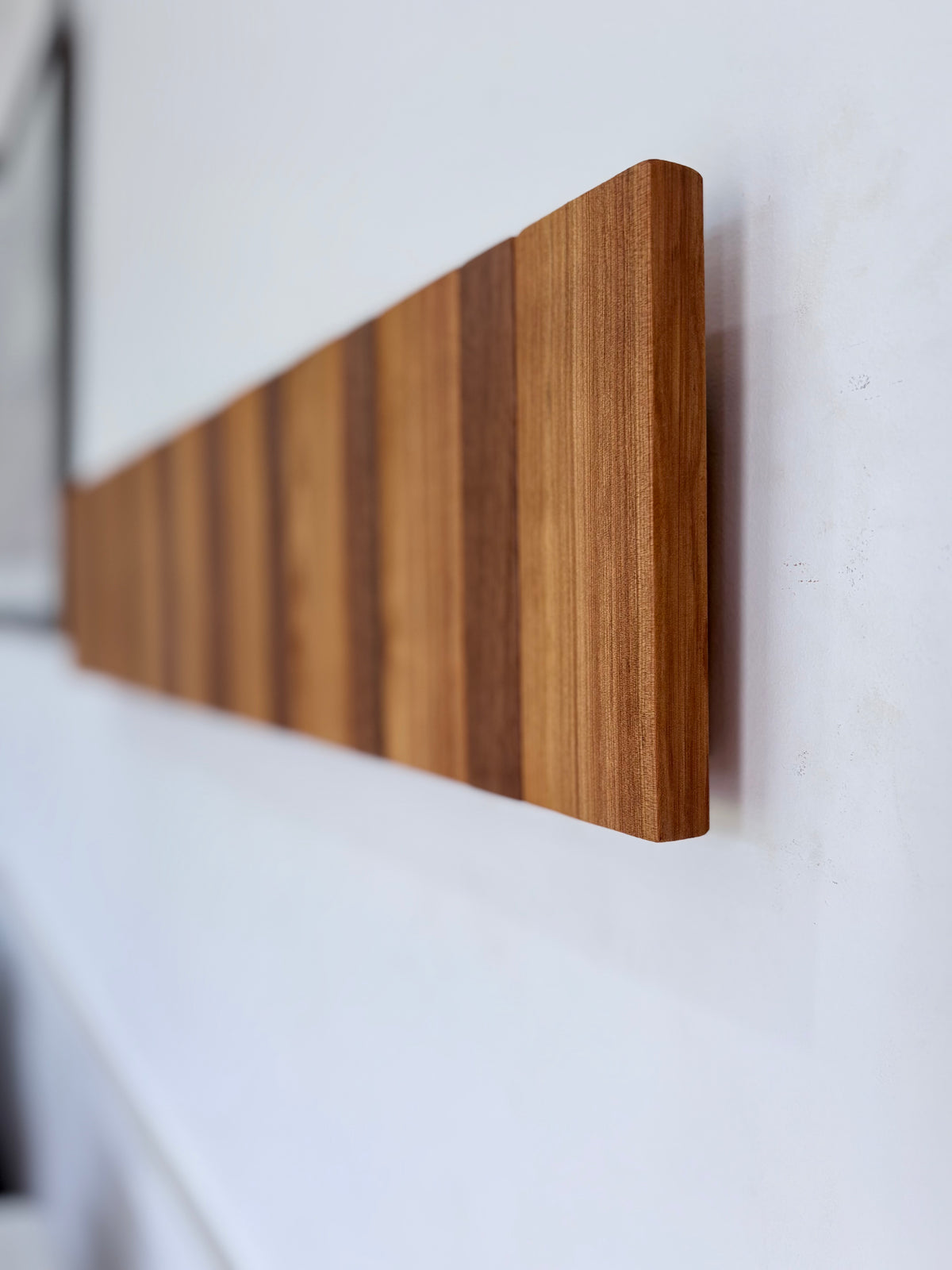 Two tone spotted gum and cypress horizon line piano style coatrack