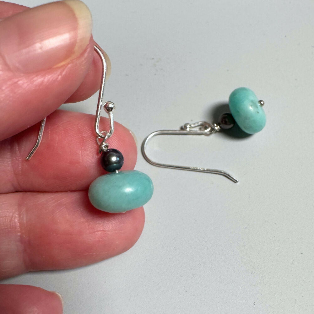 Amazonite & pearl earrings held by hand