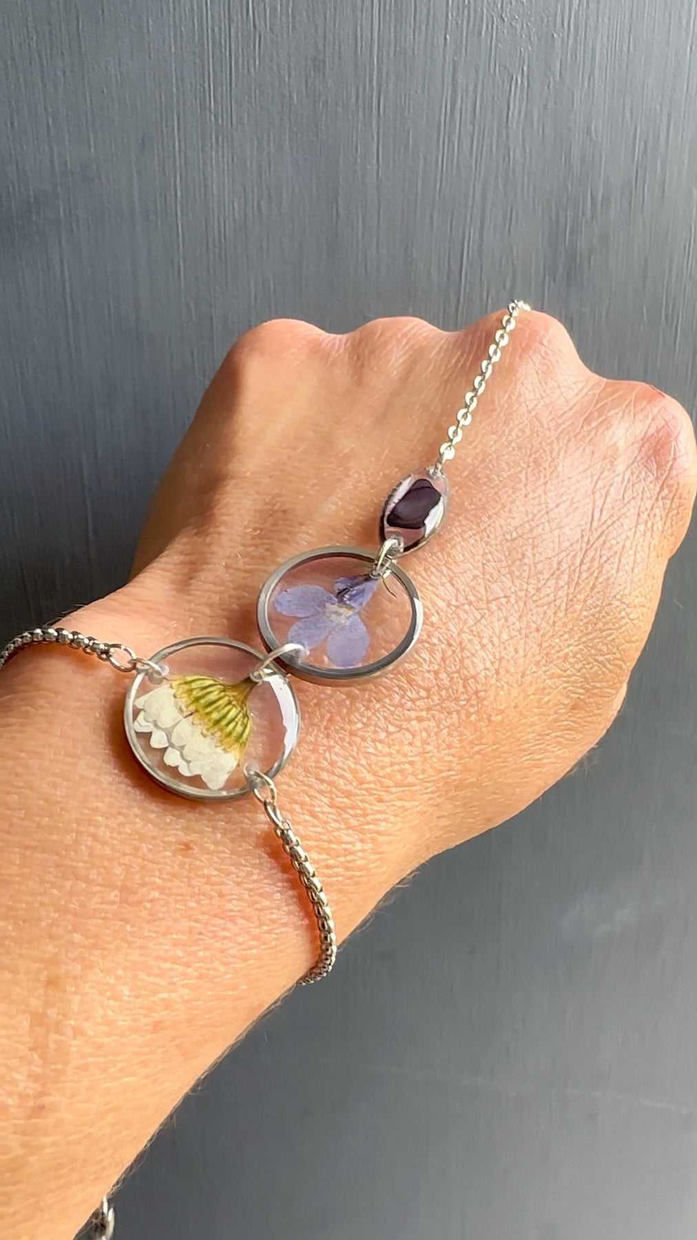 Botanical resin hand chain in silver with pressed flowers and cowrie shell