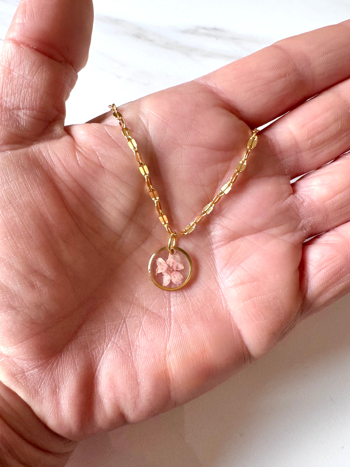Gold plated resin necklace with pink wildflower