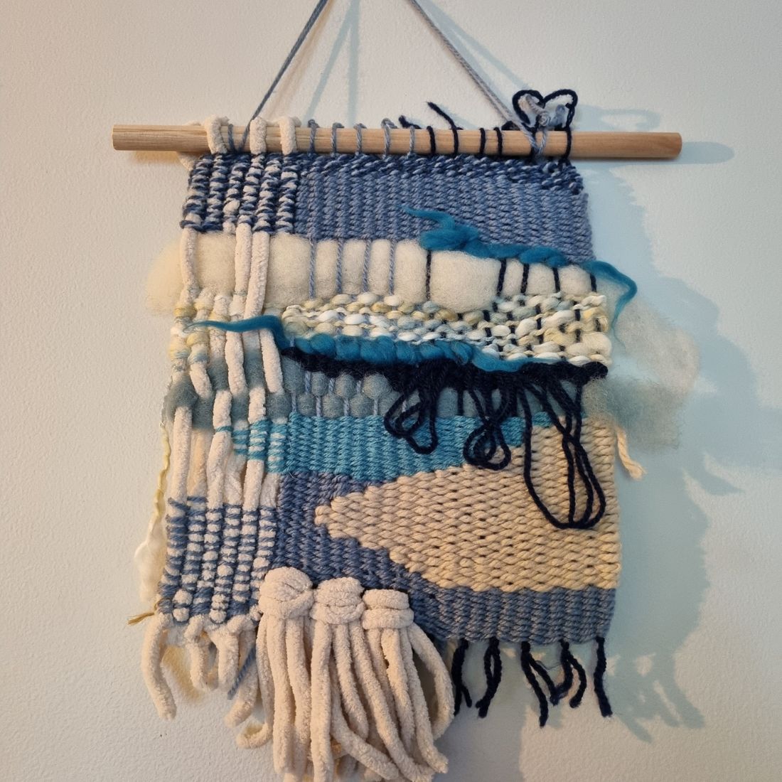 Handwoven wall hanging in blue and cream