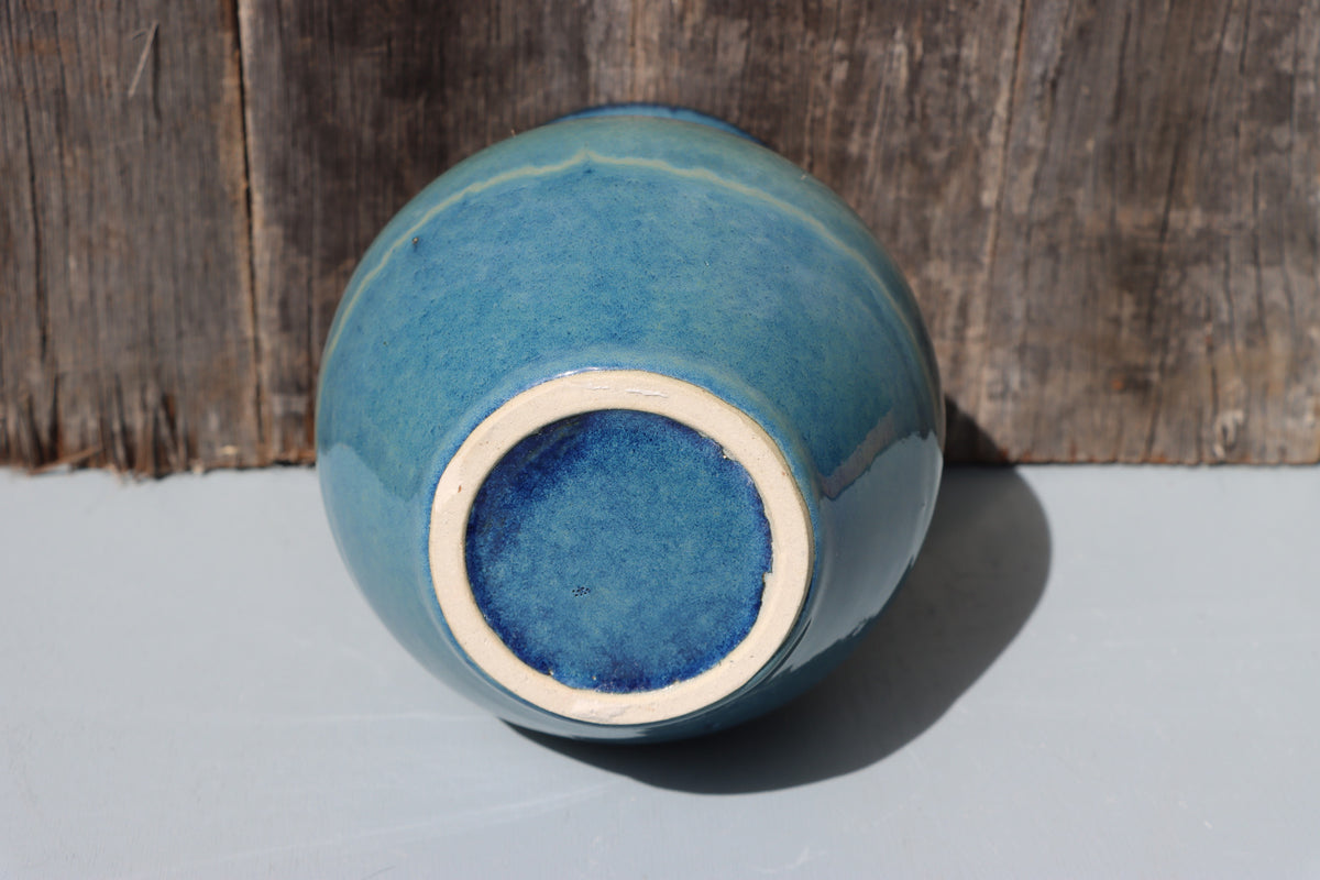 Large blue stoneware vase with blue green speckled glaze on buff clay
