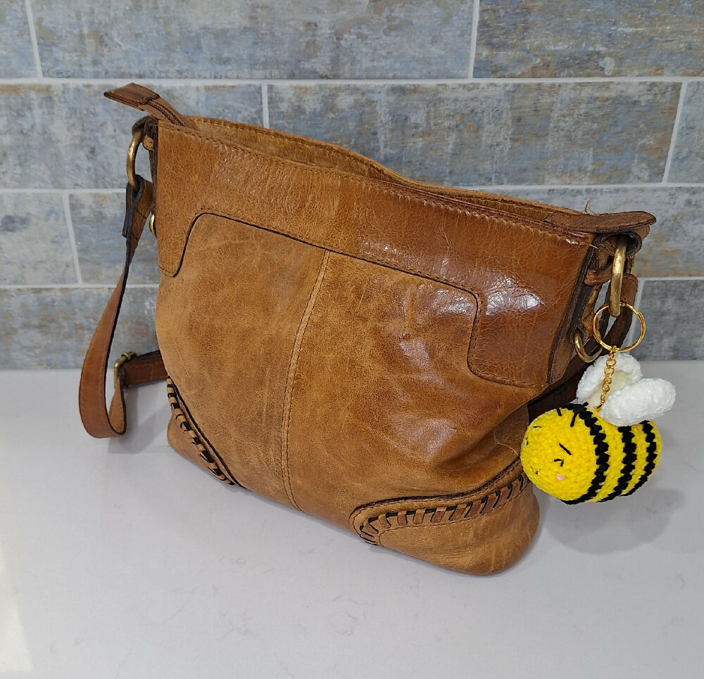 bee keychain on handbag