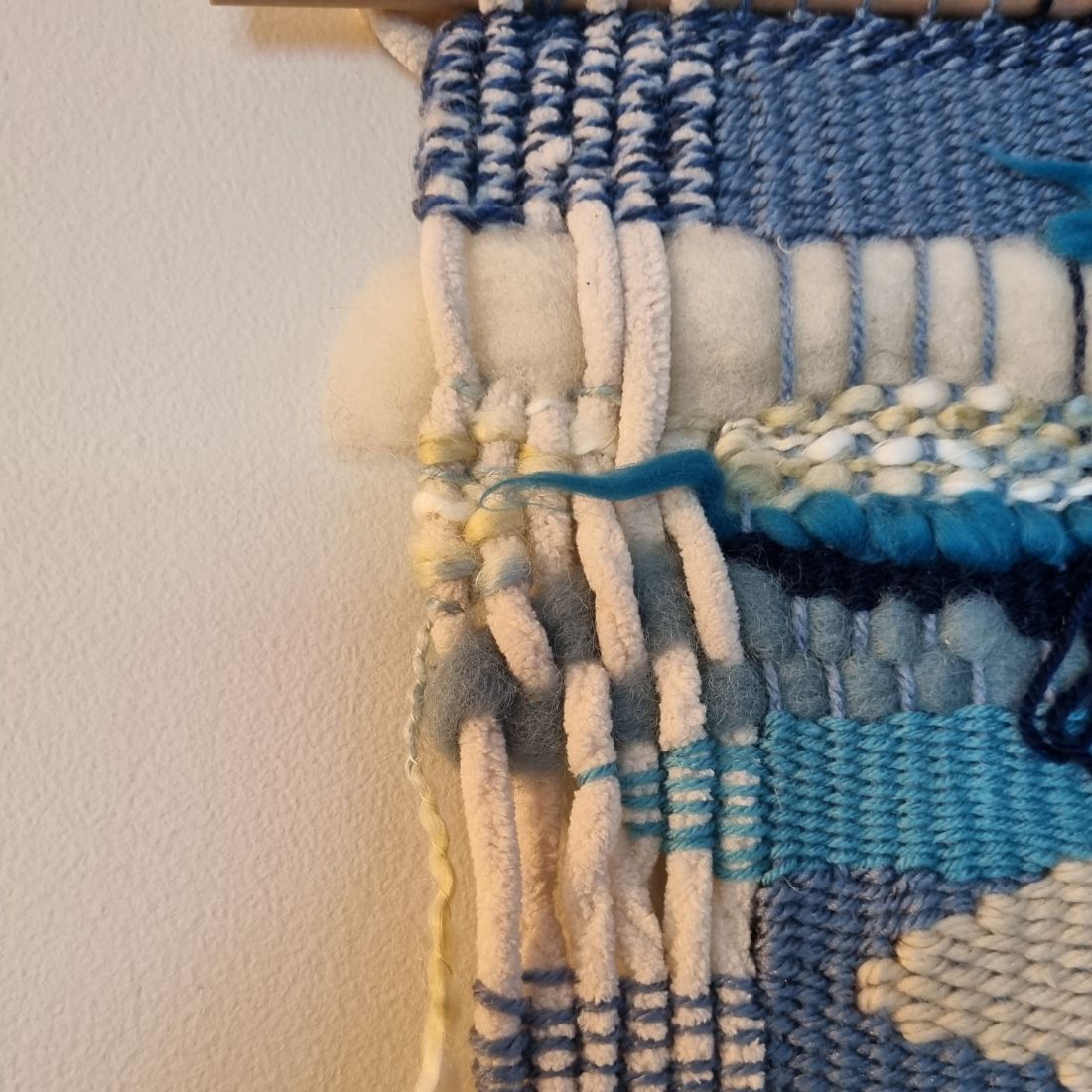 Handwoven wall hanging in blue and cream