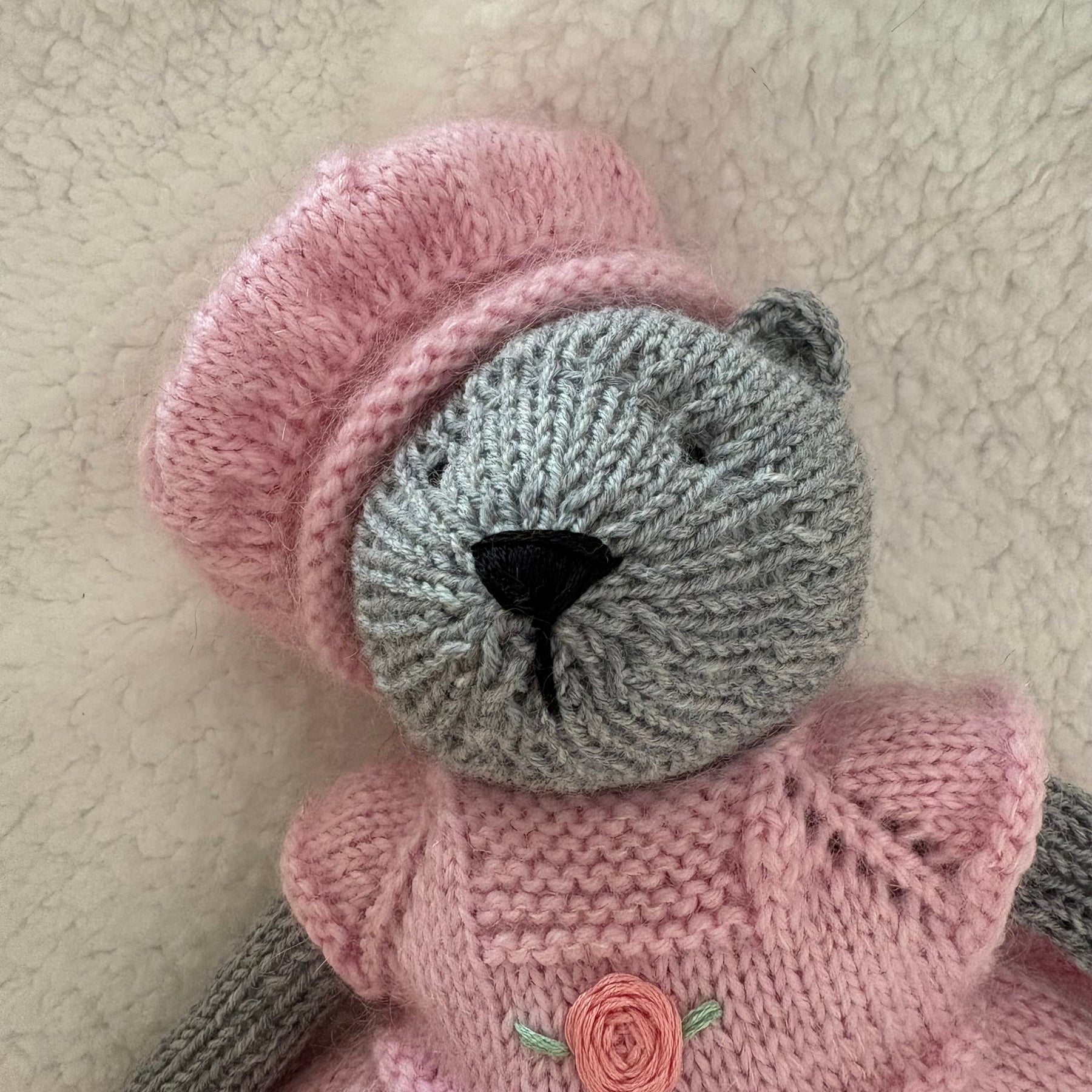 Little knitted bear in dress and beret