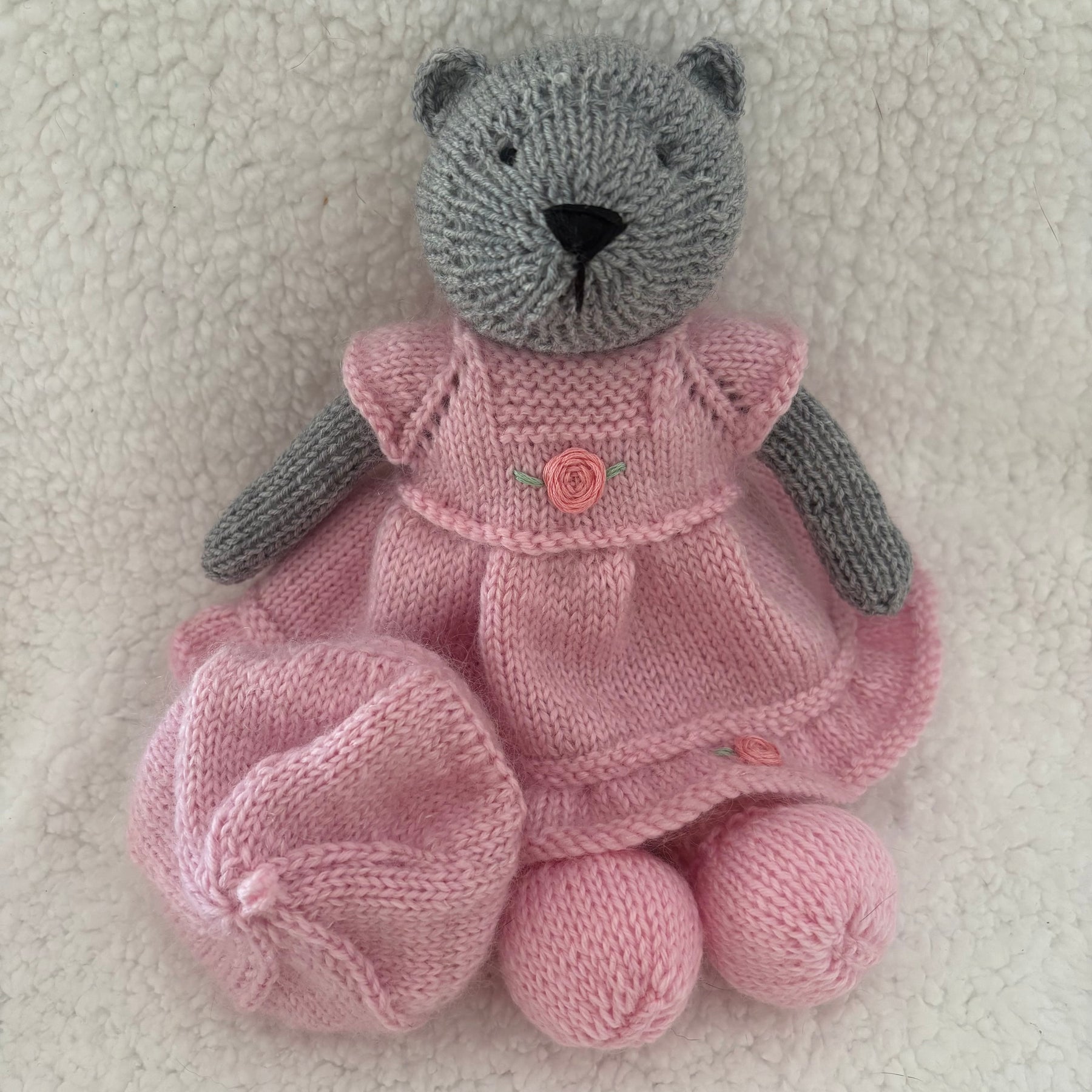 Little knitted bear in dress and beret