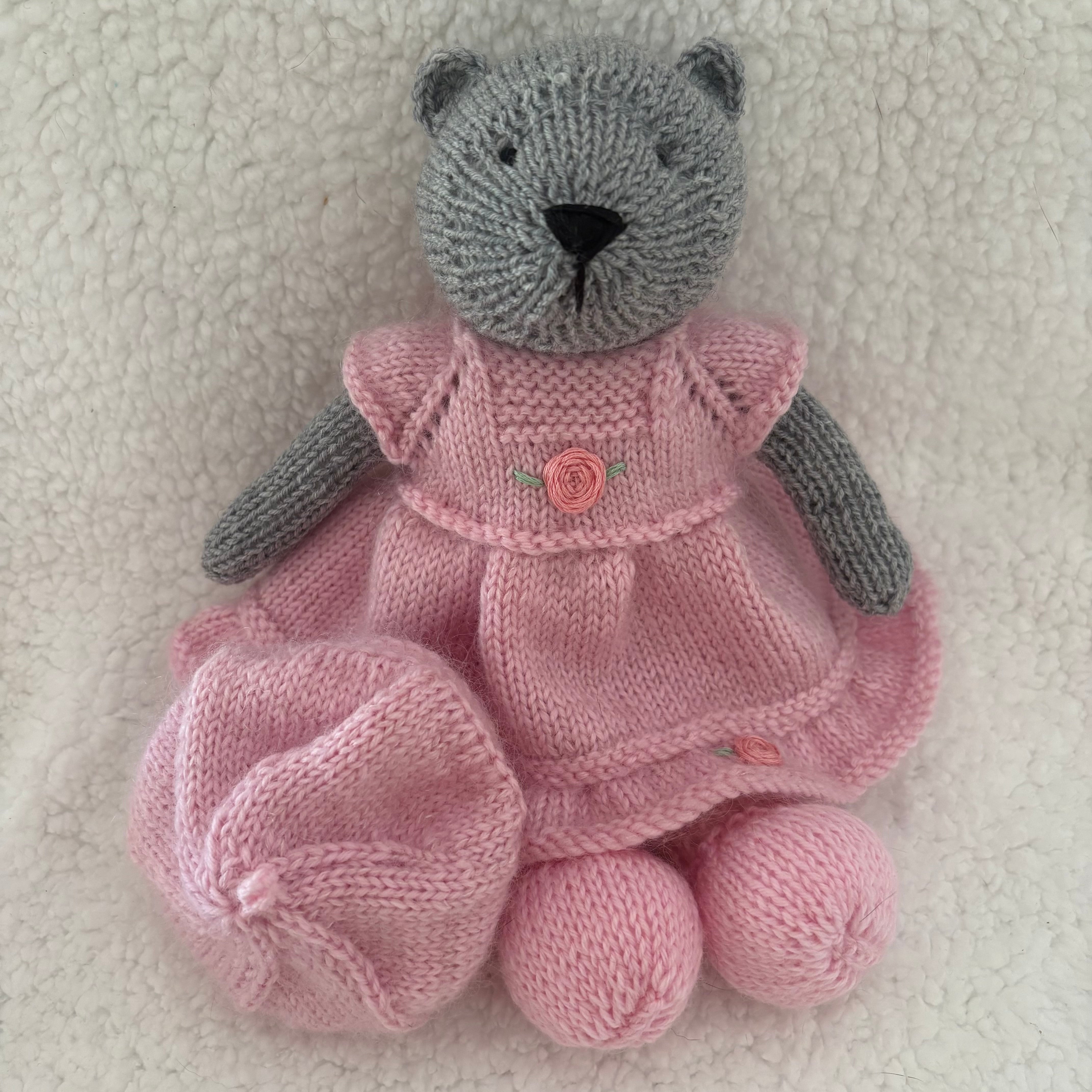 Little knitted bear in dress and beret