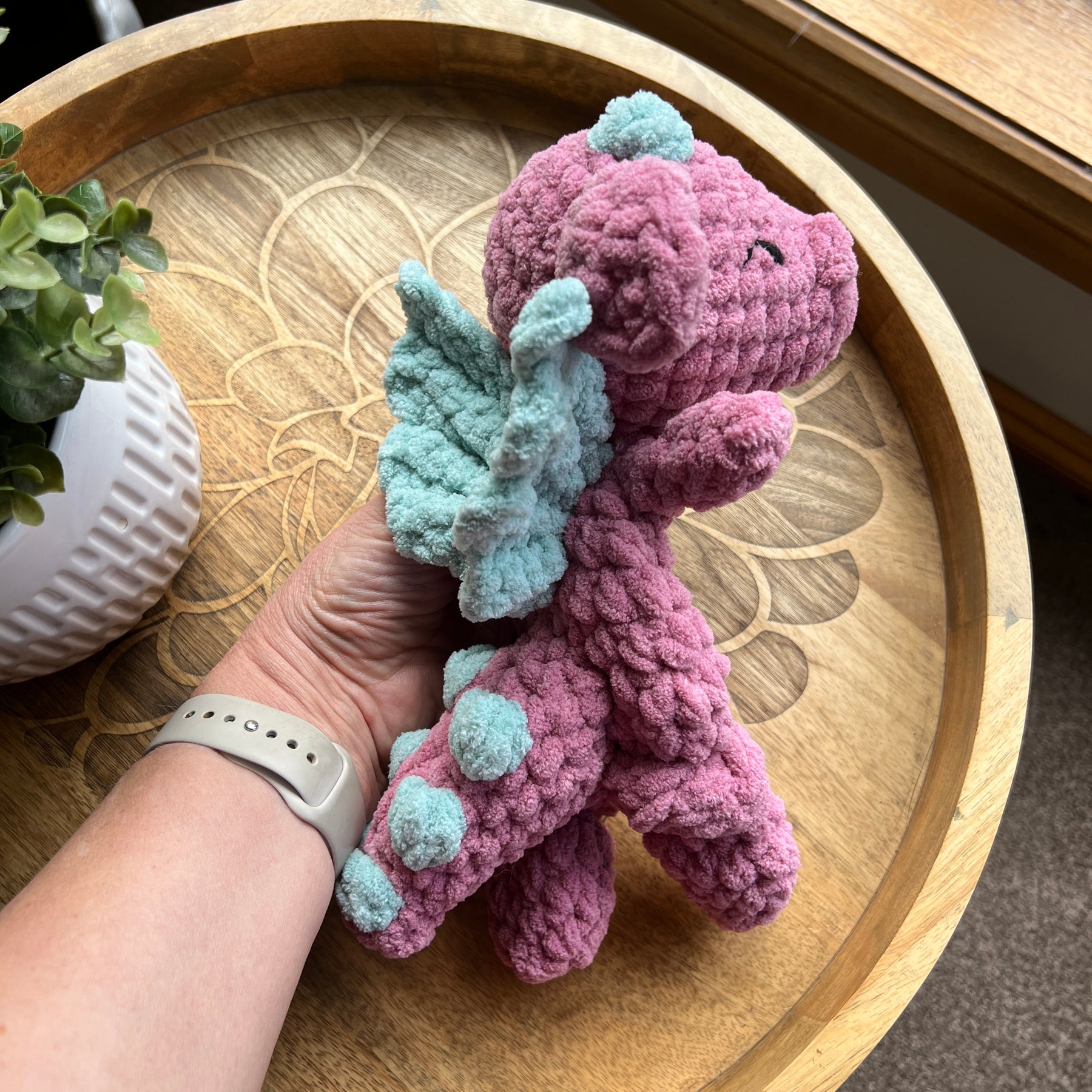 Handmade crochet Mini Dragon modern lovey with knotted legs and rainbow spikes.