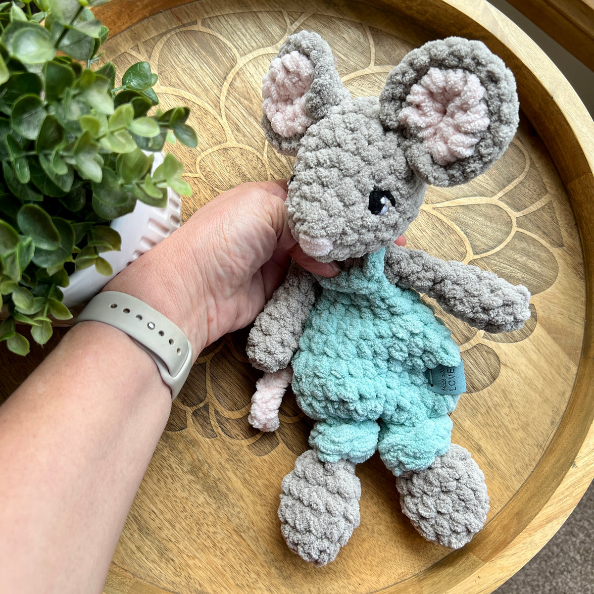 Handmade crochet Mini Mouse modern lovey in overalls with knotted legs.