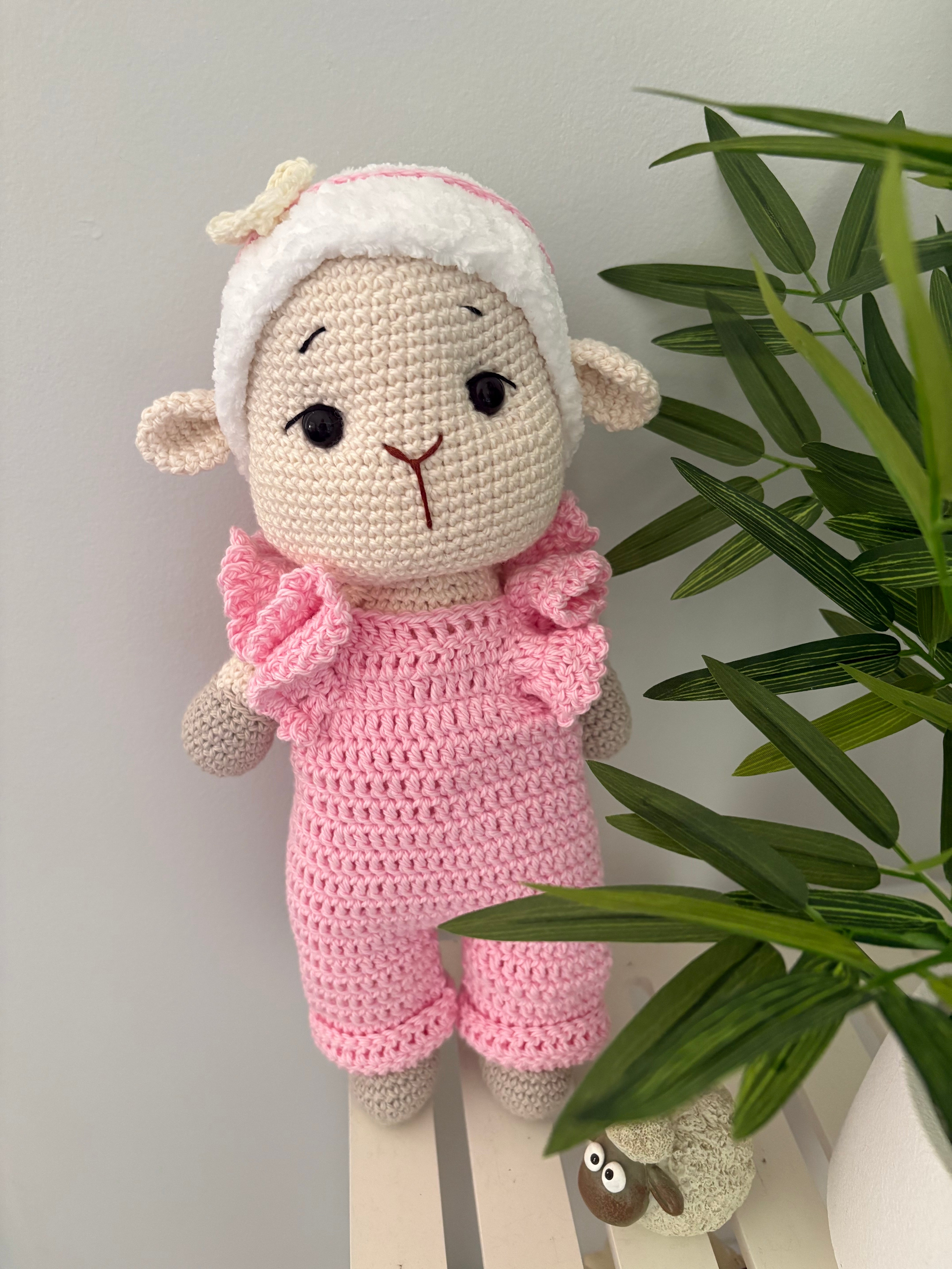Crochet lamb in pink overalls with heart headband