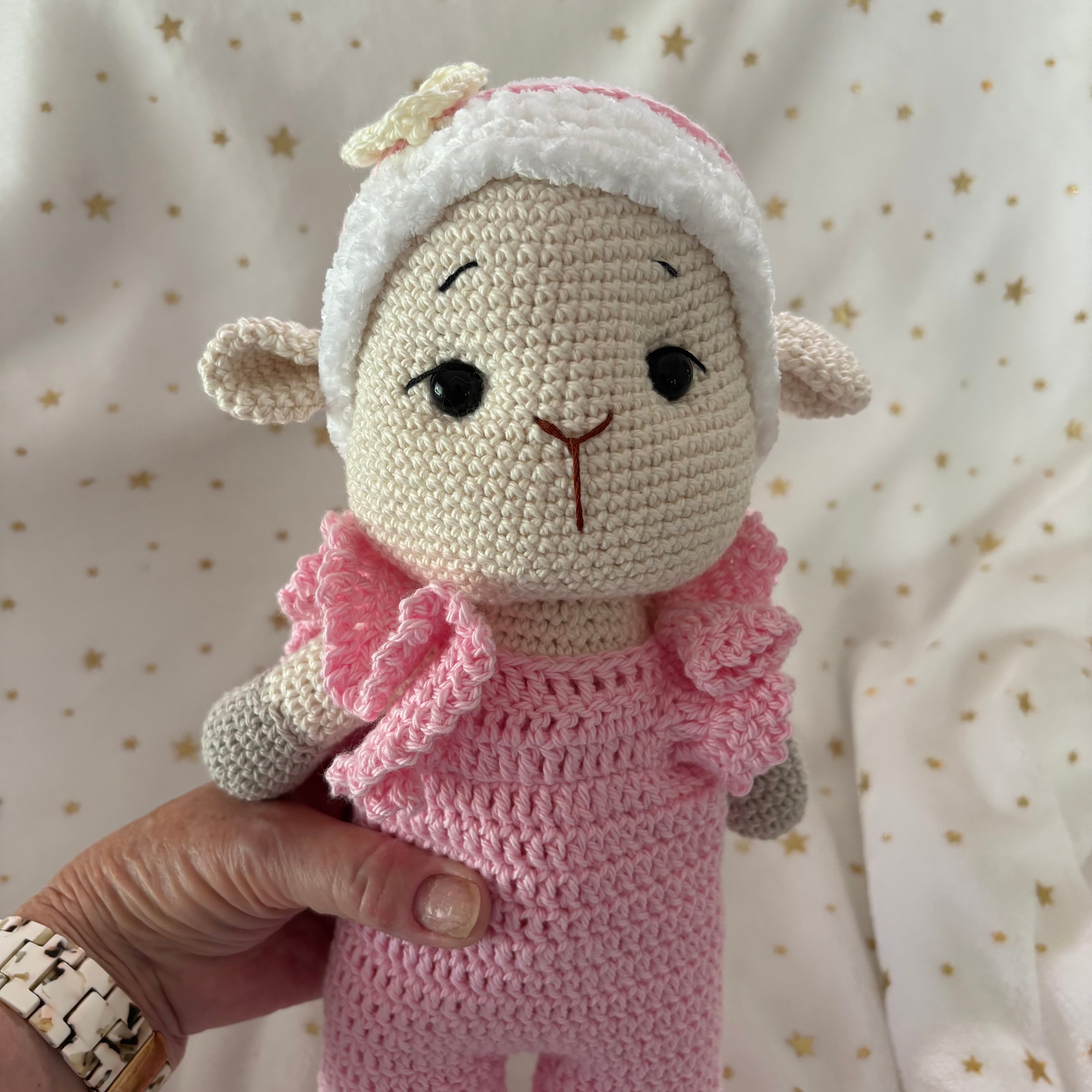 Crochet lamb in pink overalls with heart headband