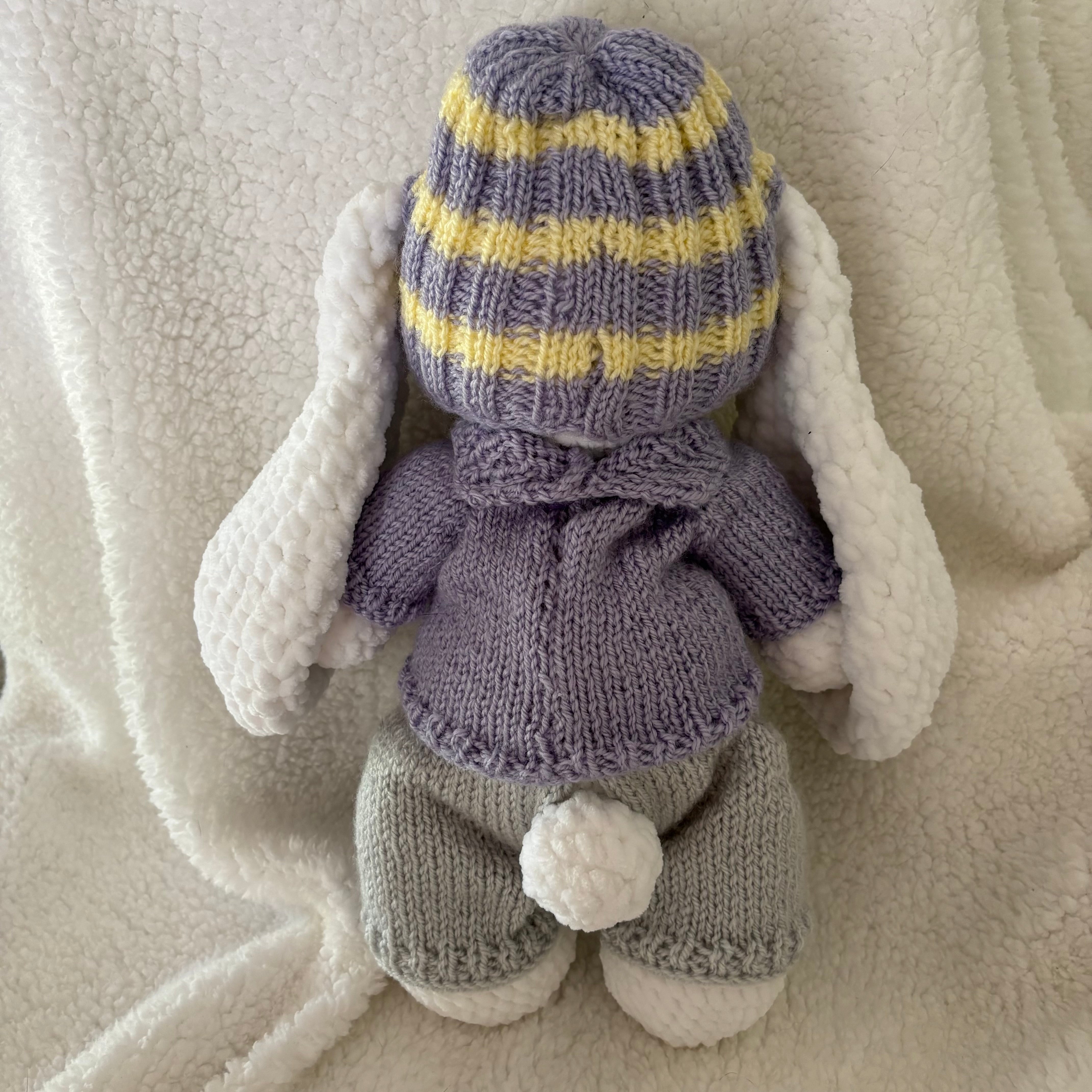 Fluffy bunny in knitted outfit