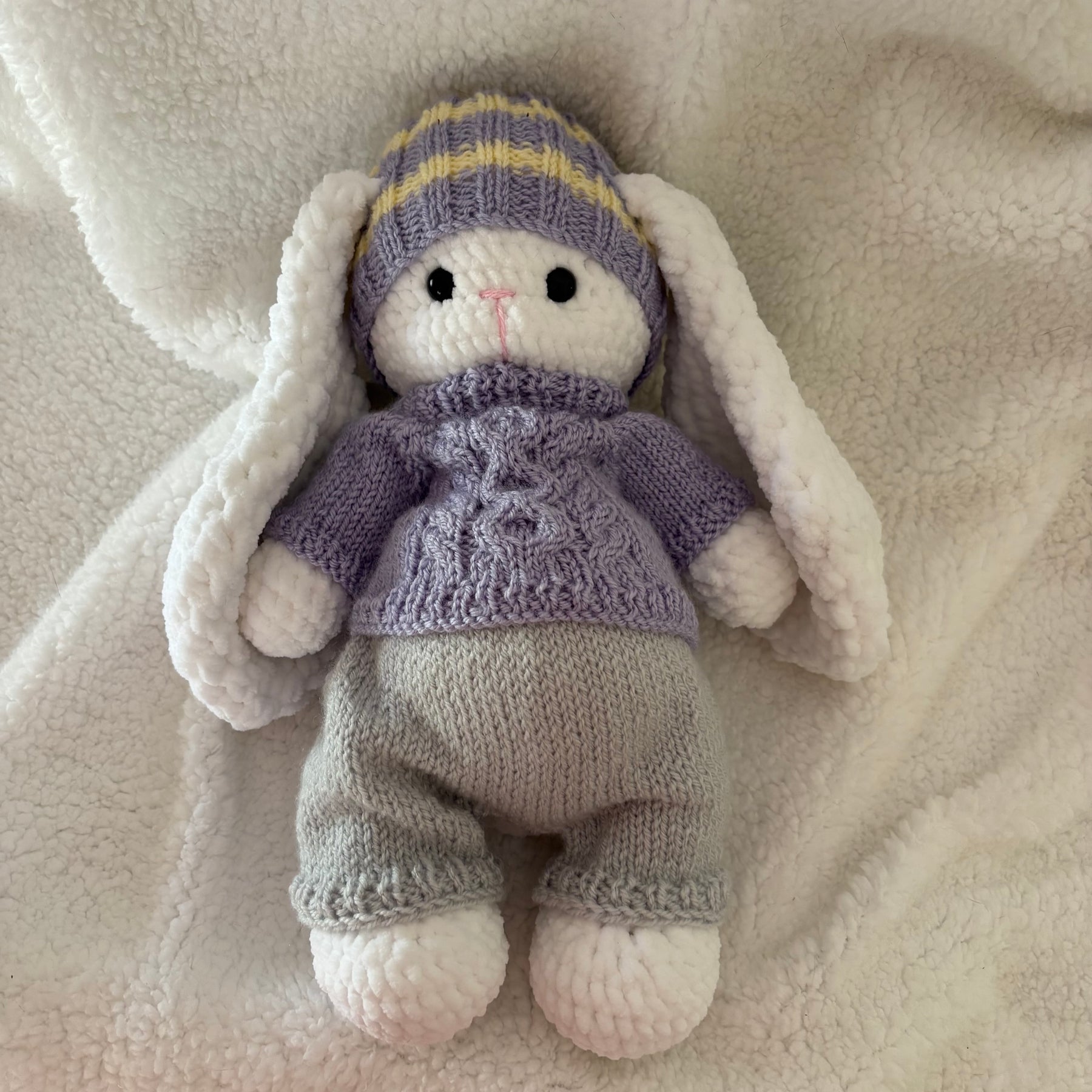 Fluffy bunny in knitted outfit
