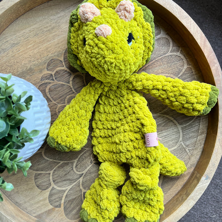 Handmade modern crochet Triceratops lovey snuggler with knotted legs baby safe.