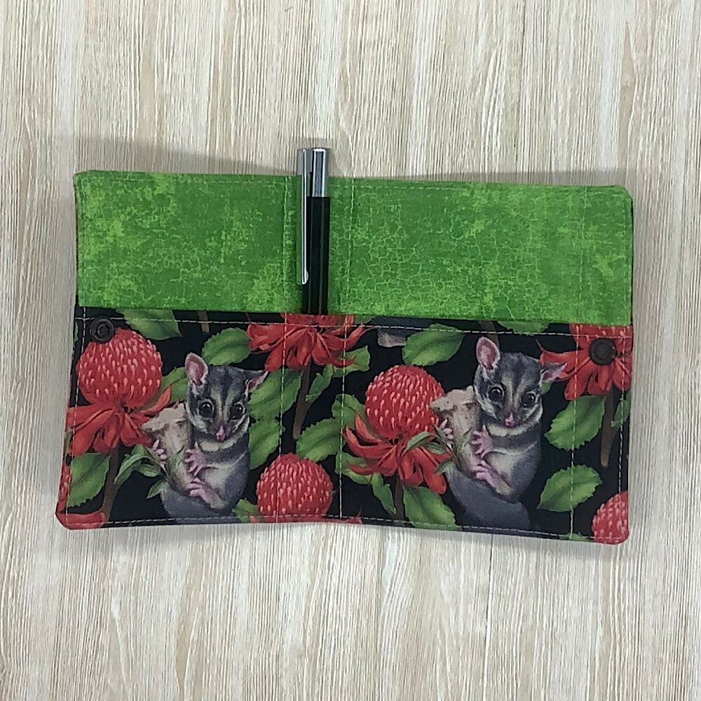 Possums refillable fabric pocket notepad cover with snap closure. Incl. book and pen.