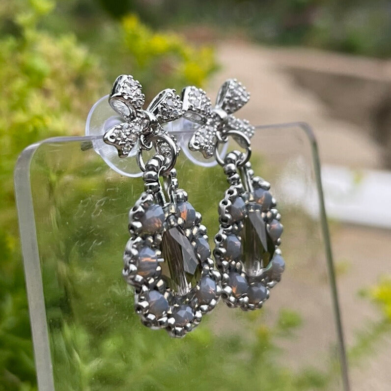 Bow Silver and grey intricate beaded earrings