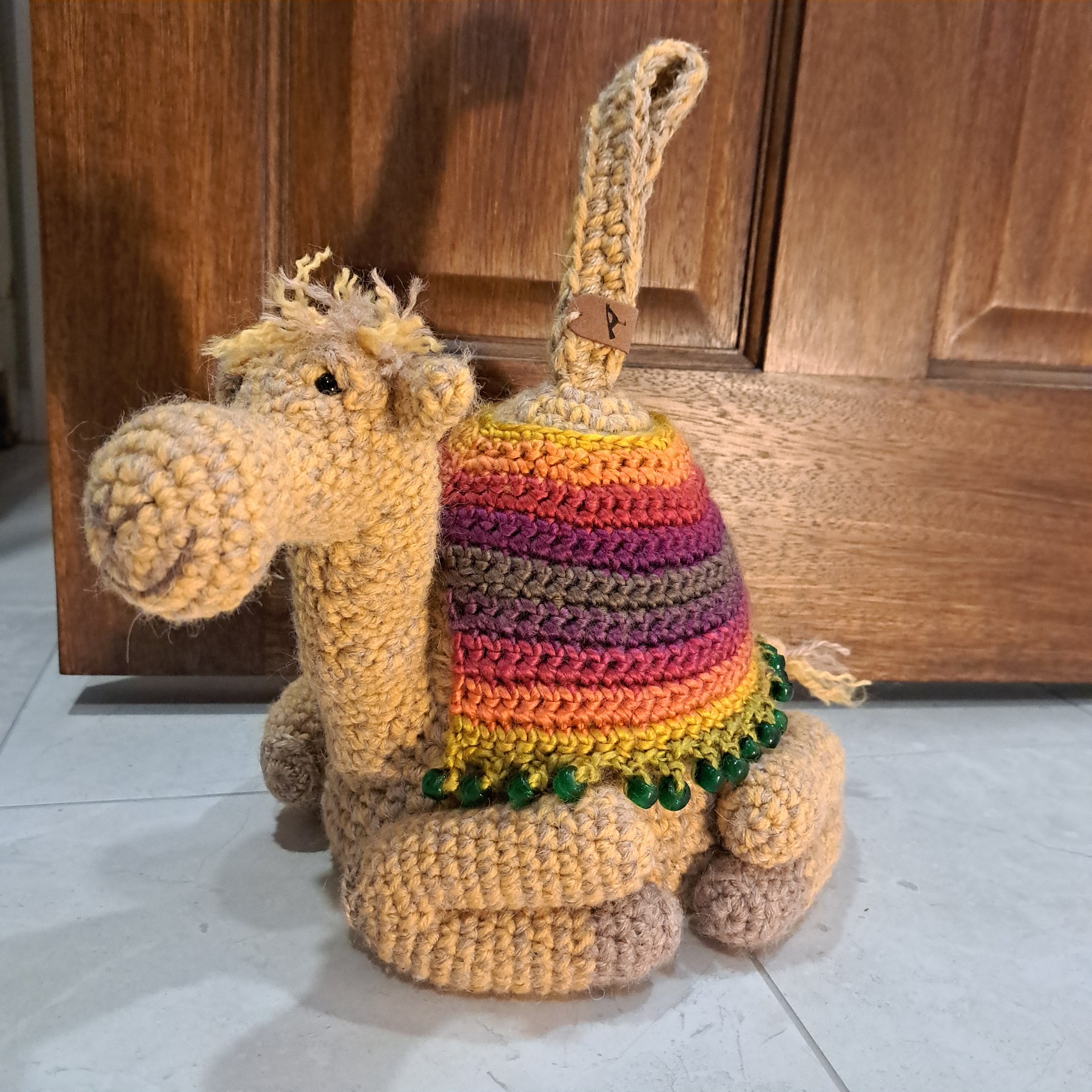 Handmade crochet camel doorstop colourful coat mustard coloured base