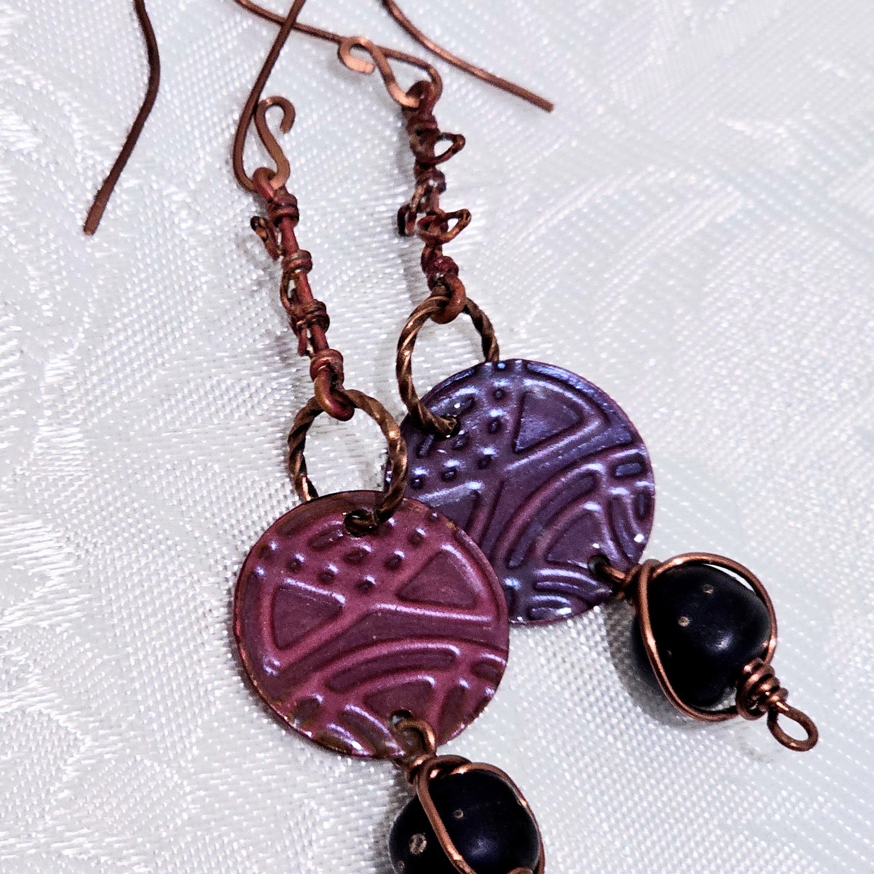 Suspended Pressed Metal Discs with Barbed Wirework Link and Black Matt Lampwork bead